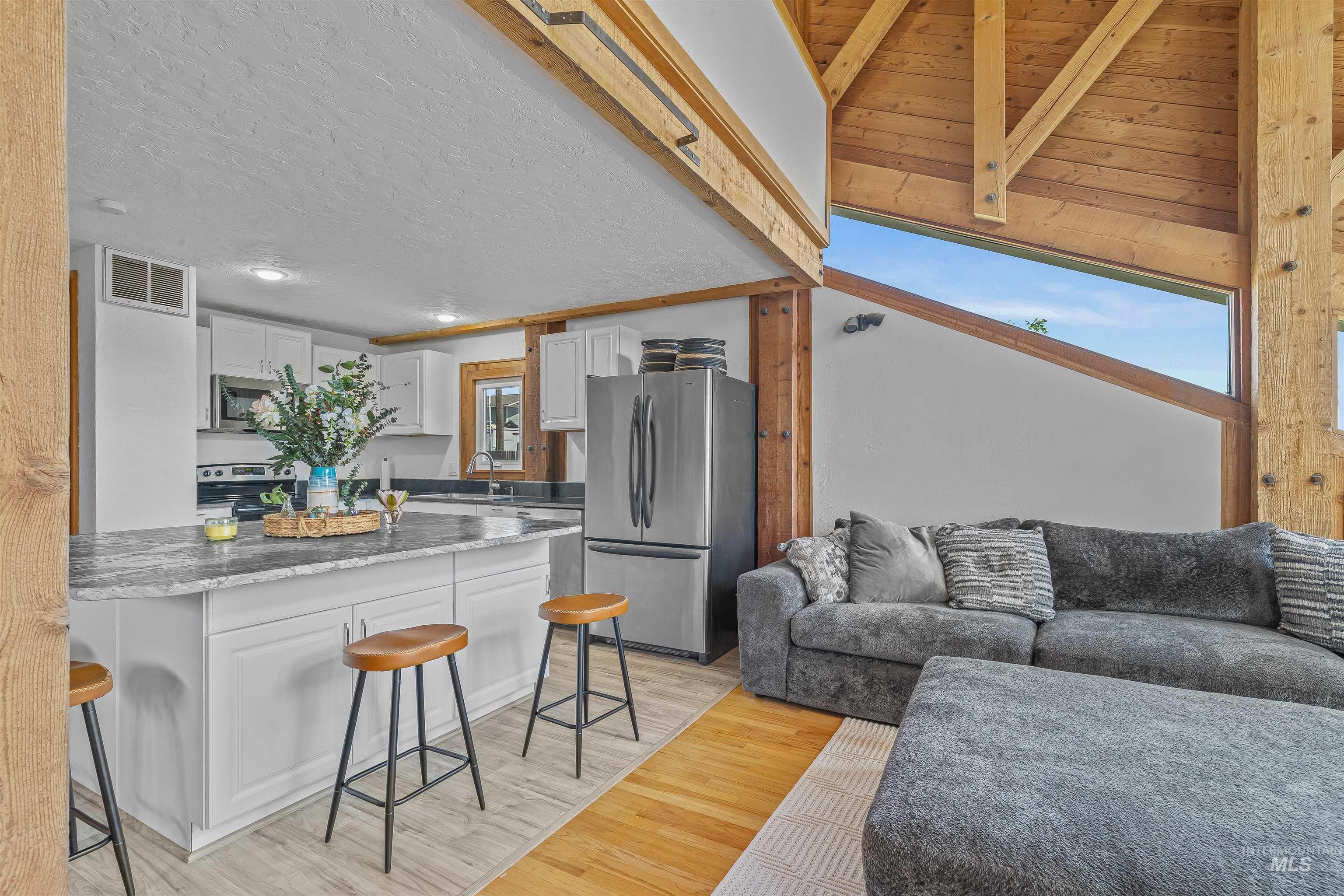 Living room featuring light wood-style flooring, recessed lighting, and a textured ceiling