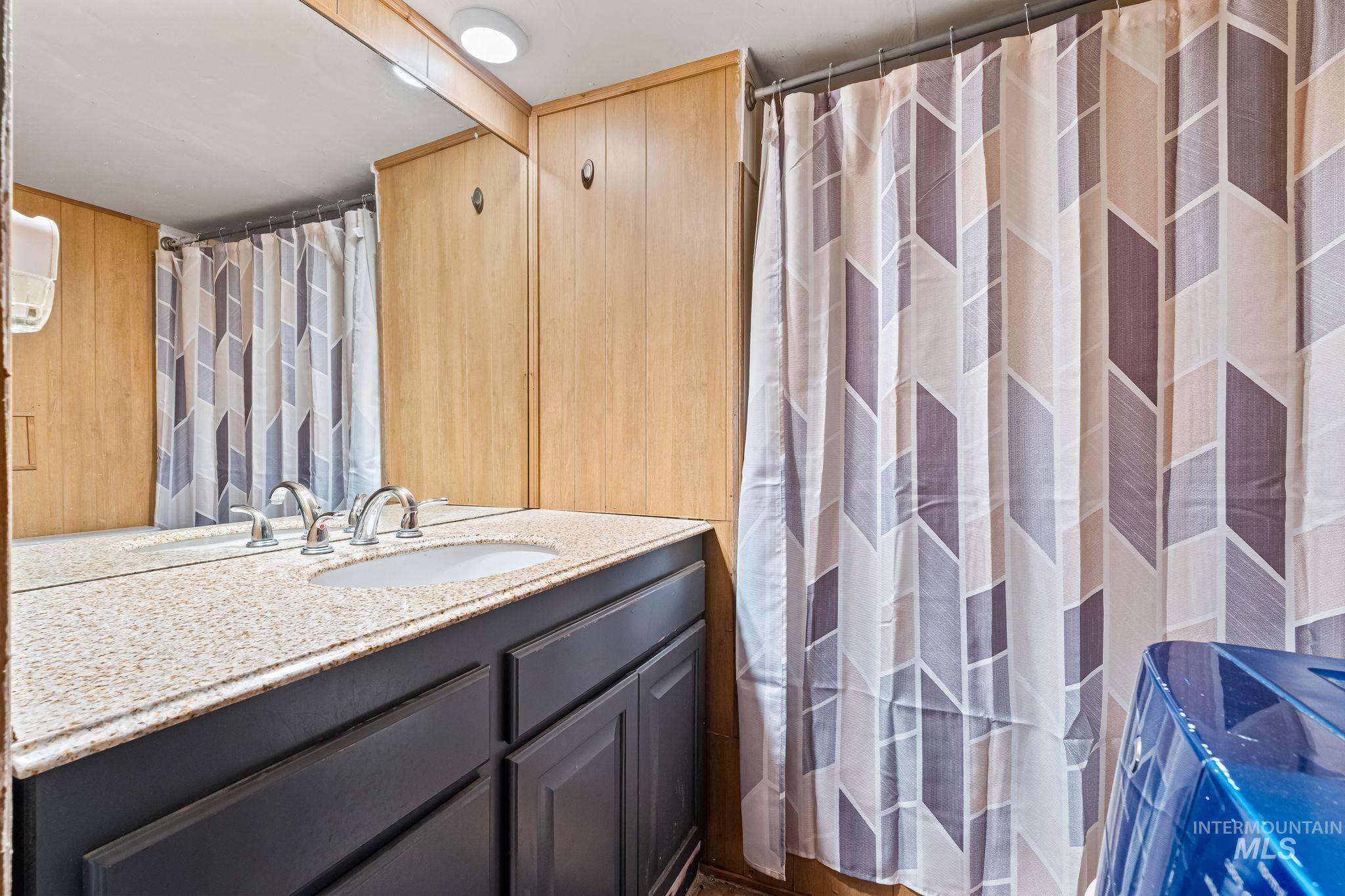 Bathroom featuring vanity and a shower with shower curtain