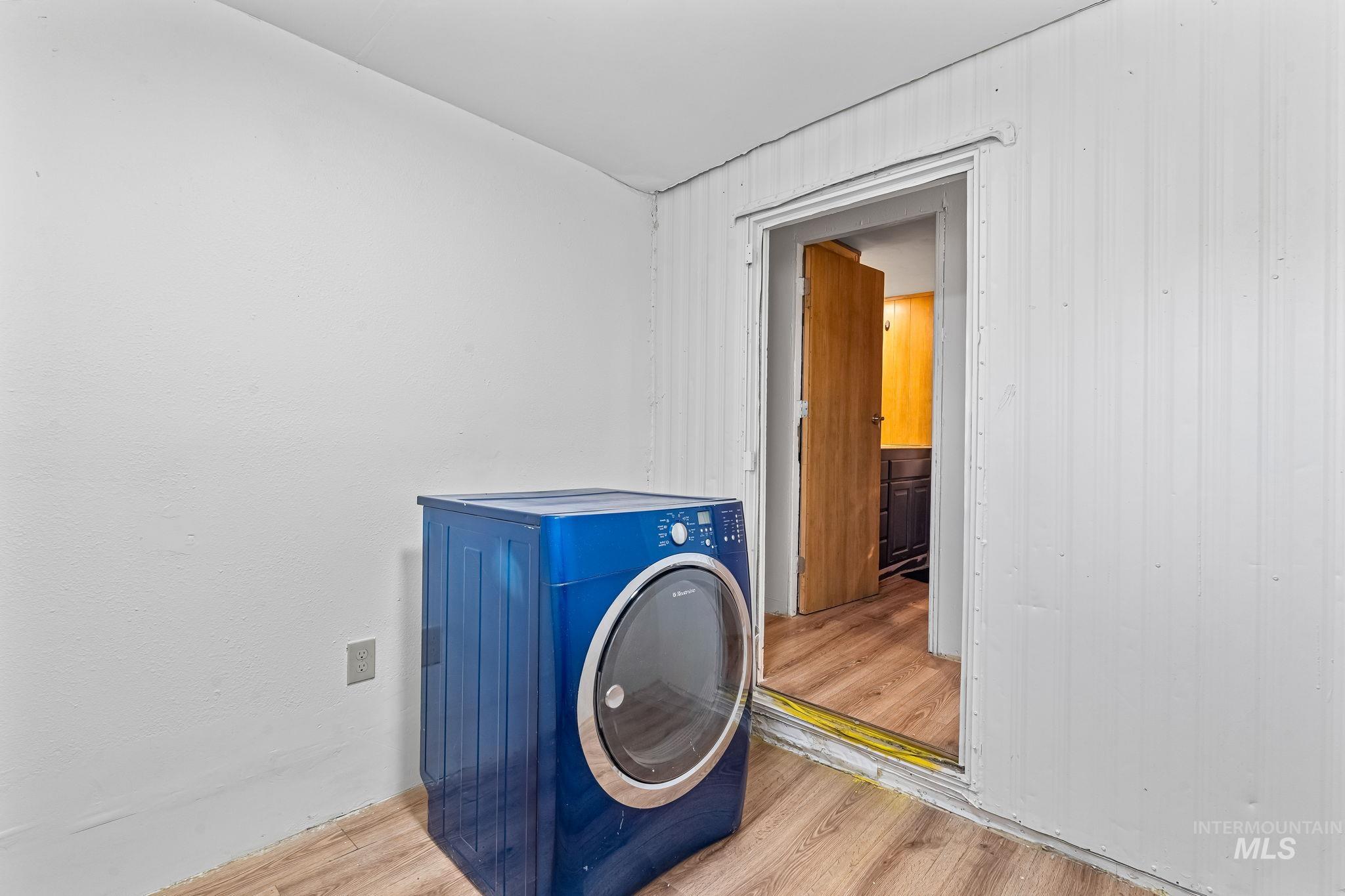 Laundry room with washer / clothes dryer and wood finished floors