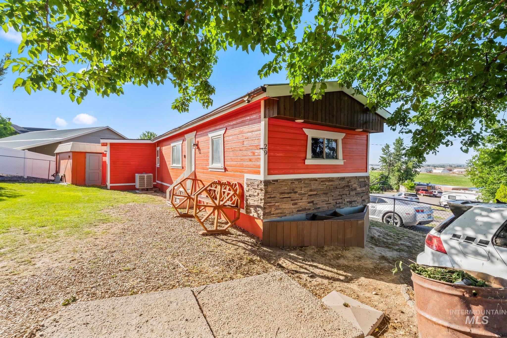 View of home's exterior with a storage shed and stone siding