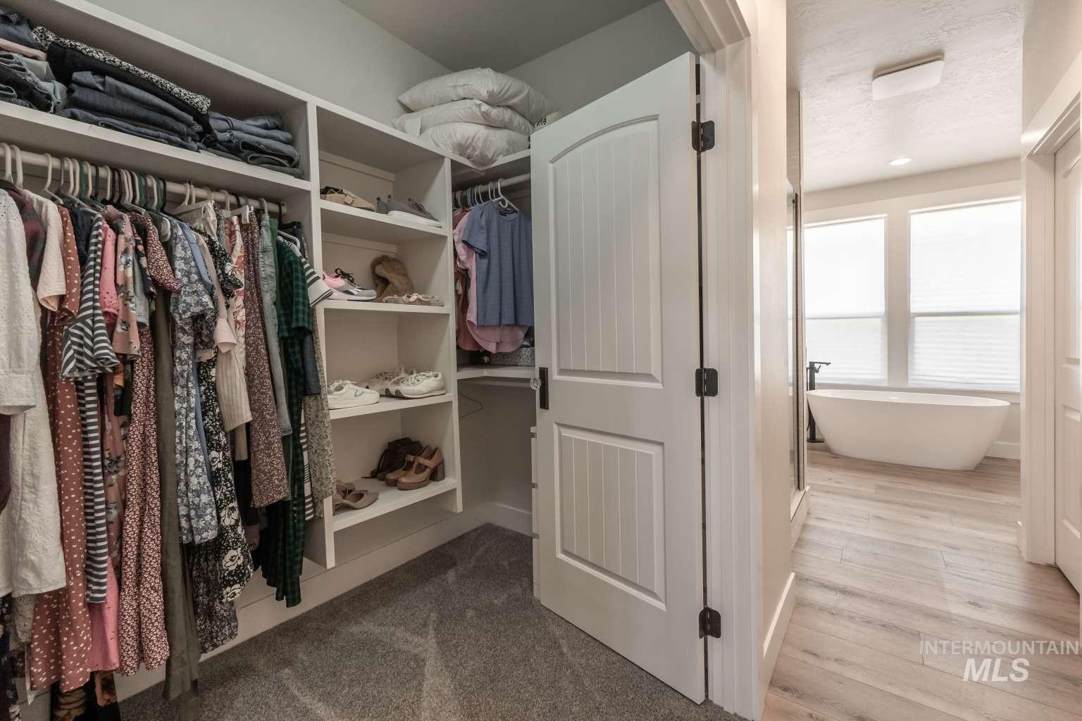 Walk in closet featuring wood finished floors