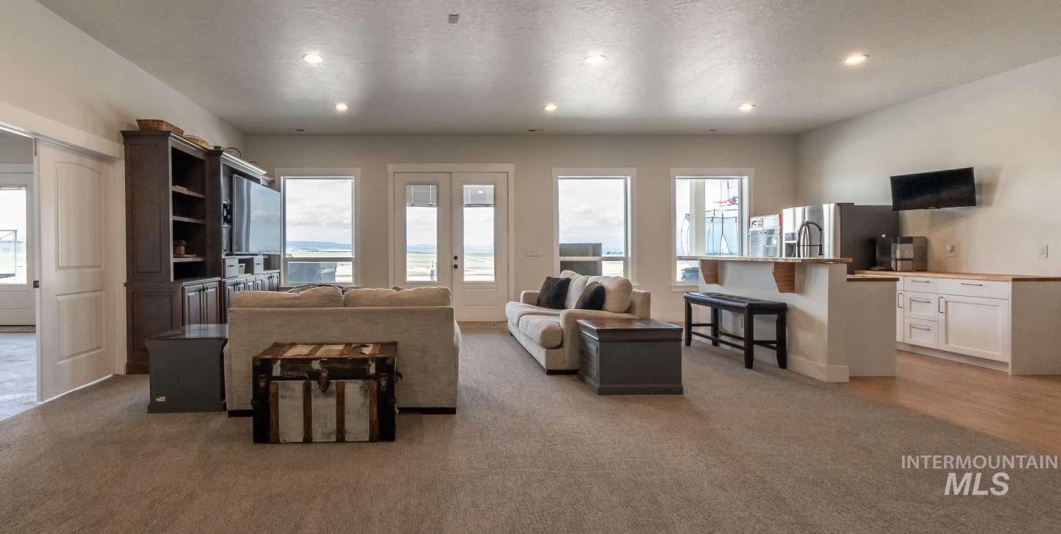 Living room with light colored carpet, recessed lighting, and french doors