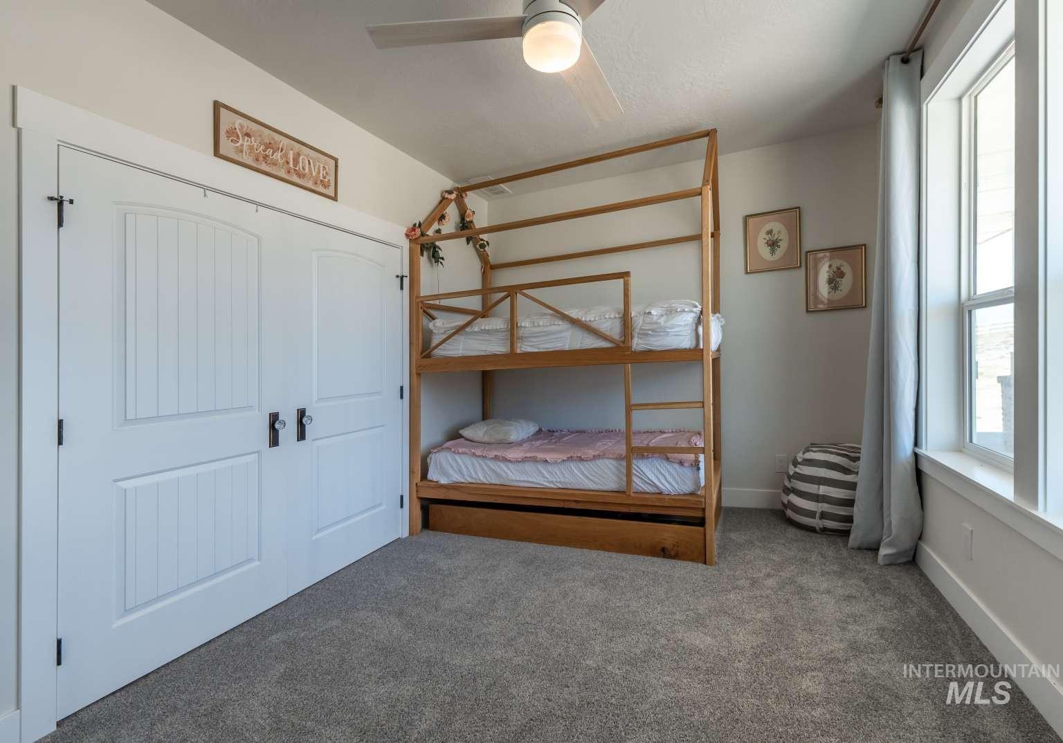 Carpeted bedroom with baseboards and ceiling fan