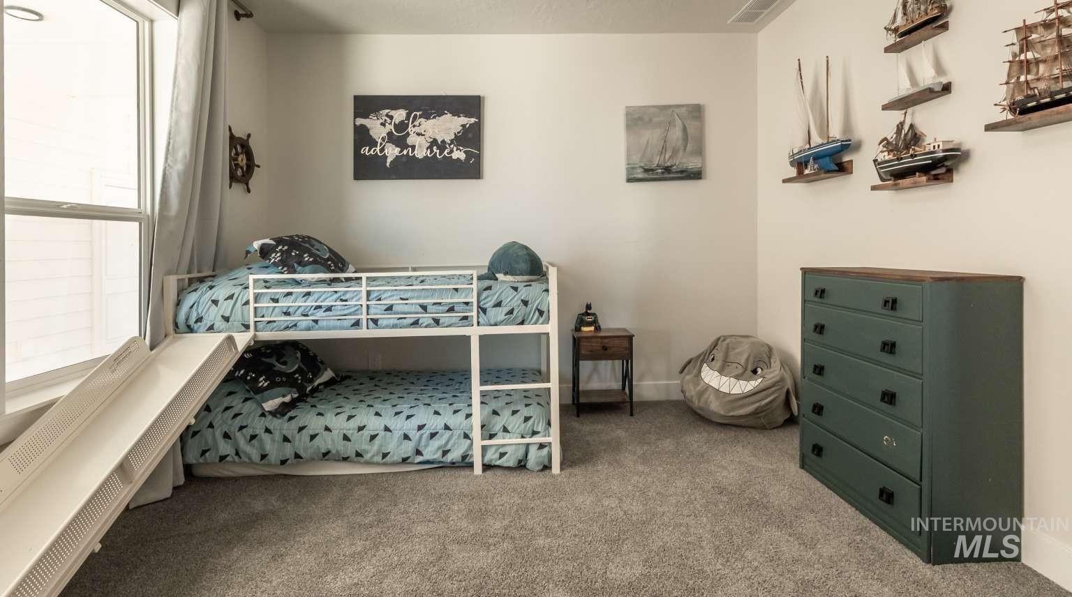 Carpeted bedroom featuring baseboards