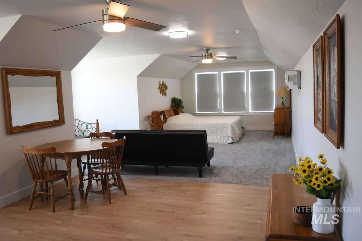 Bedroom with vaulted ceiling and wood finished floors