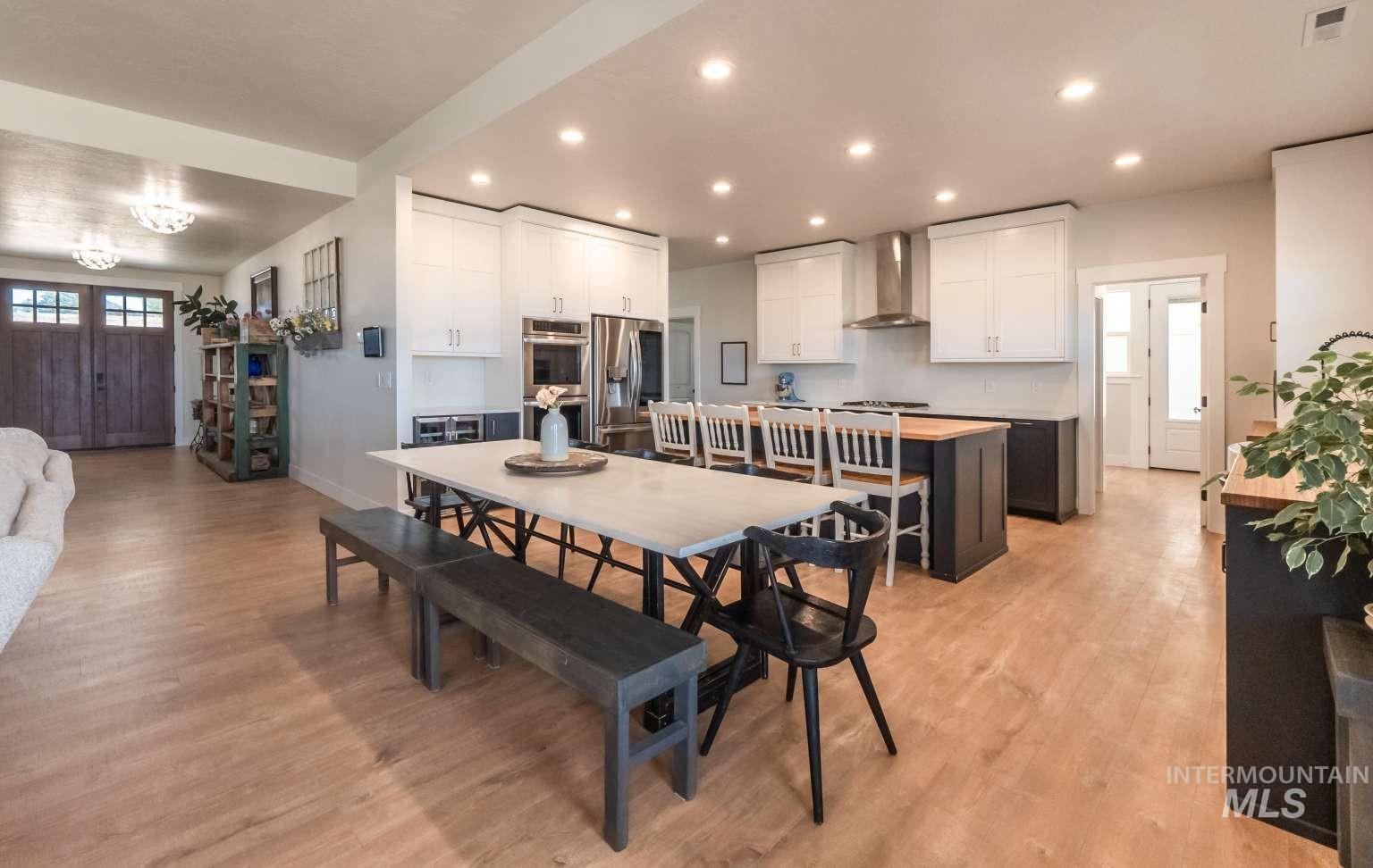 Dining area with light wood-type flooring and recessed lighting
