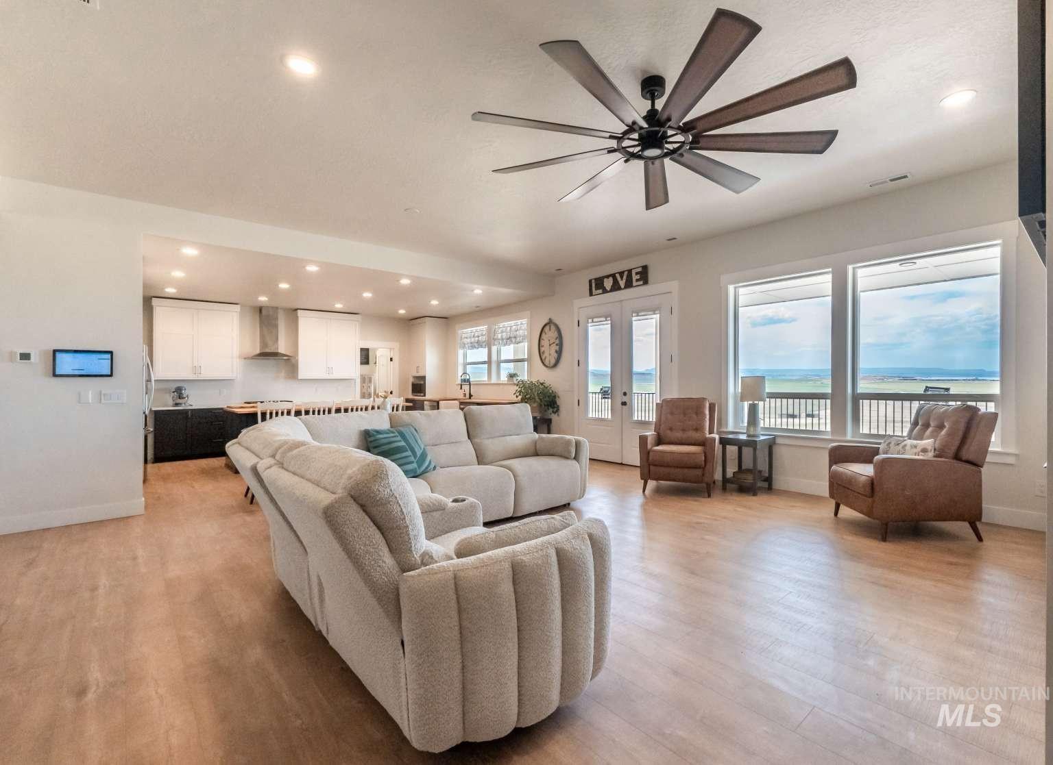 Living area with light wood finished floors, recessed lighting, and ceiling fan