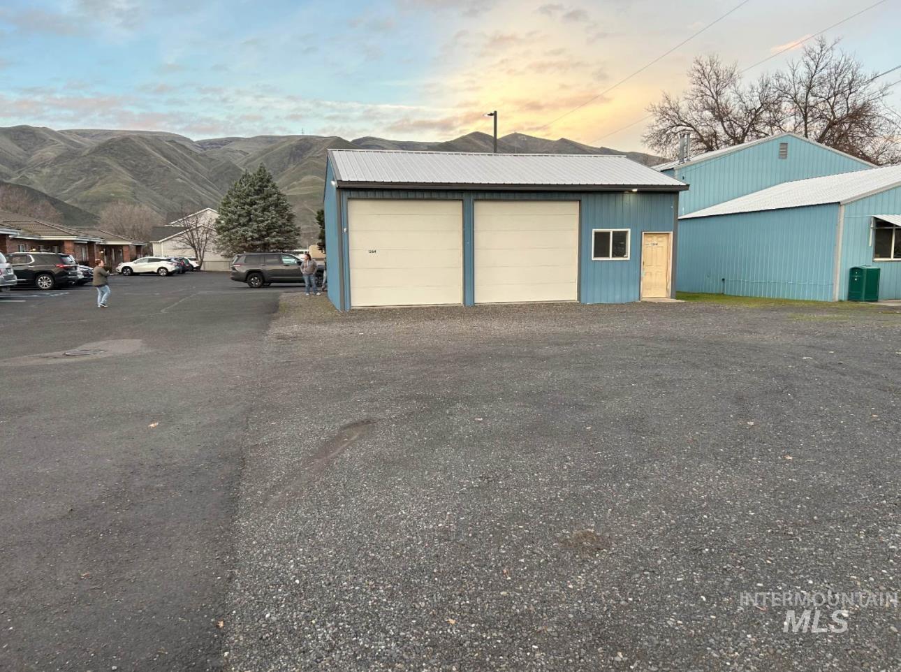 Garage at dusk with a detached garage and a mountain view