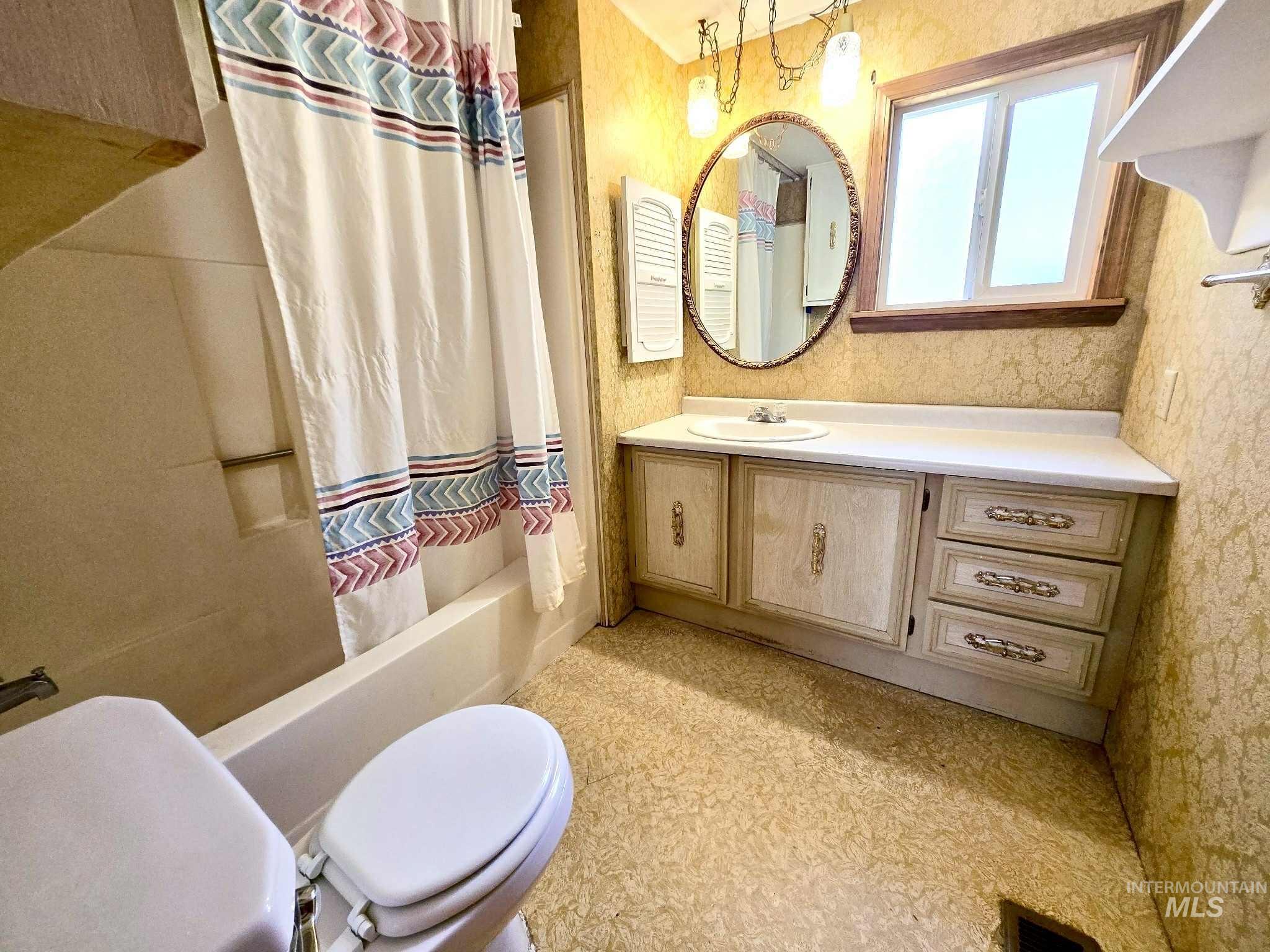 Full bathroom with shower / bath combination with curtain and vanity