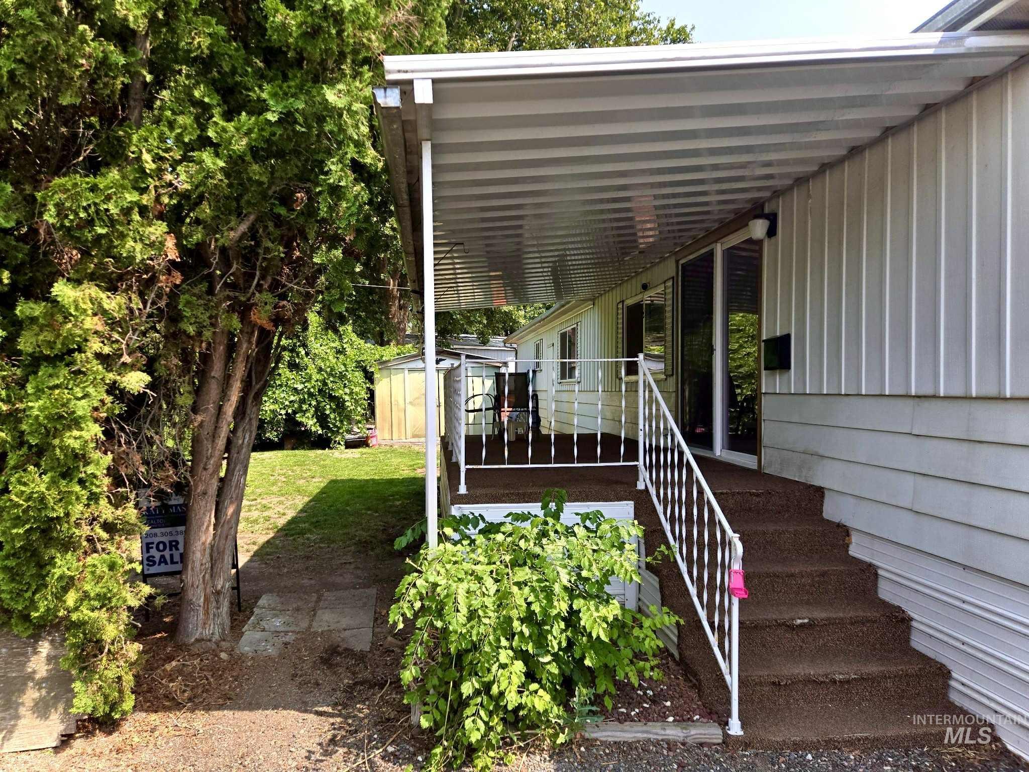 Doorway to property featuring a lawn