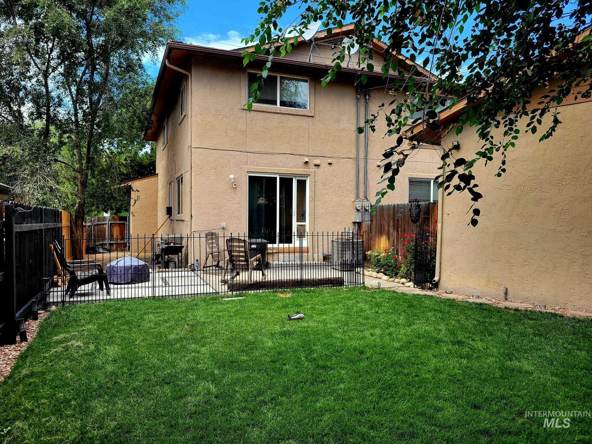 Back of house featuring a patio area, a fenced backyard, and stucco siding