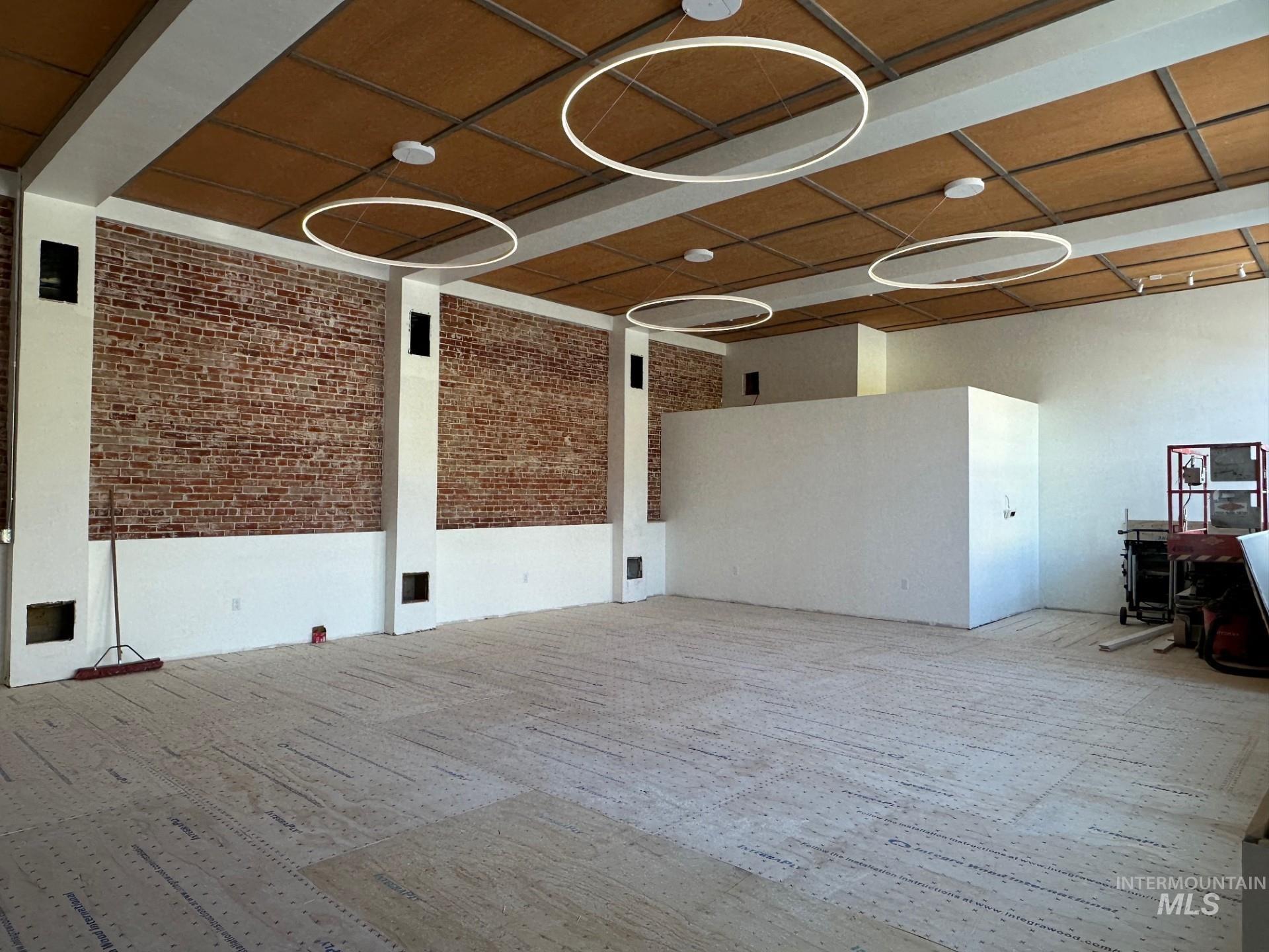 Spare room with brick wall and carpet
