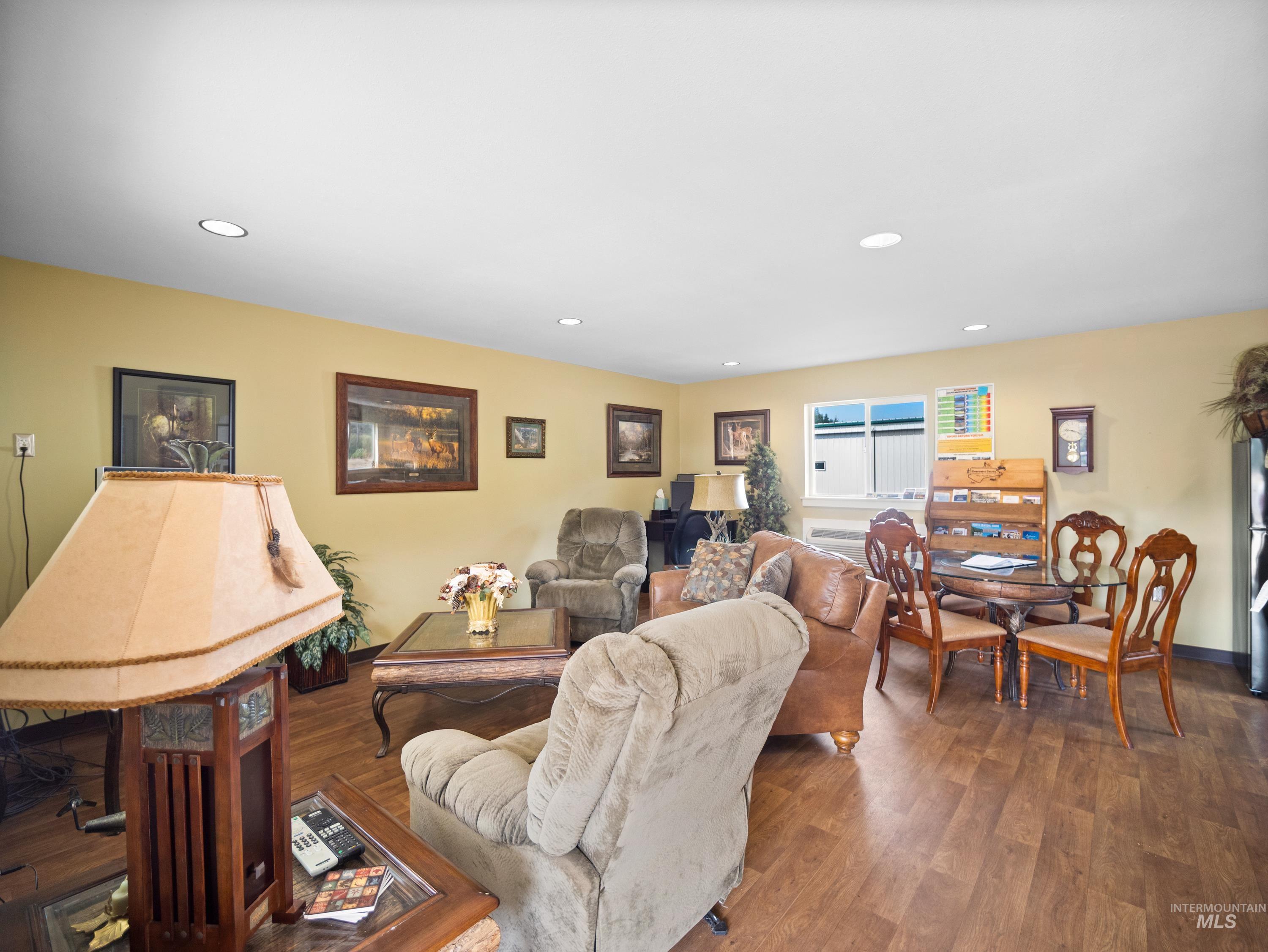 Lounge area with wood finished floors and recessed lighting