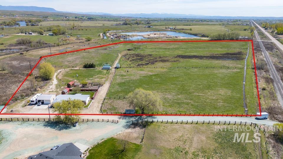 View of rural area featuring property parcel outlined and a water and mountain view