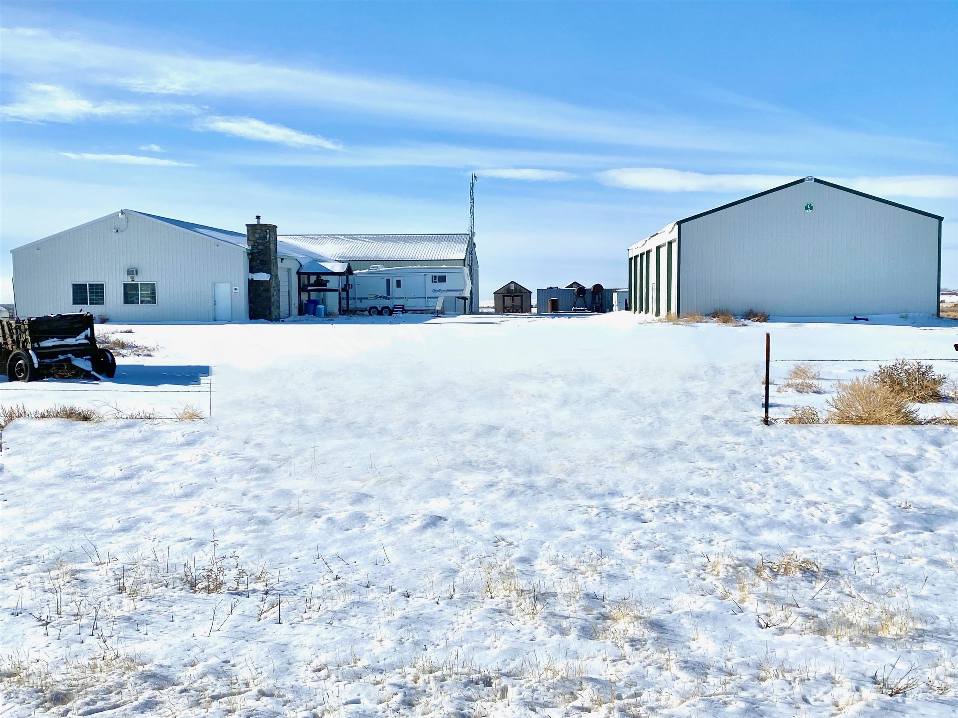 Snowy yard featuring an outbuilding