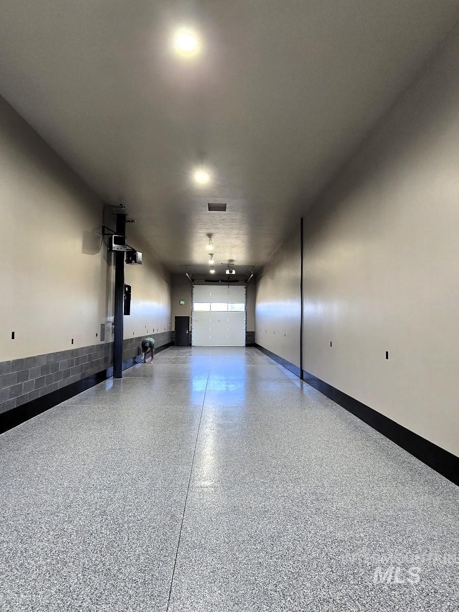 Garage featuring baseboards