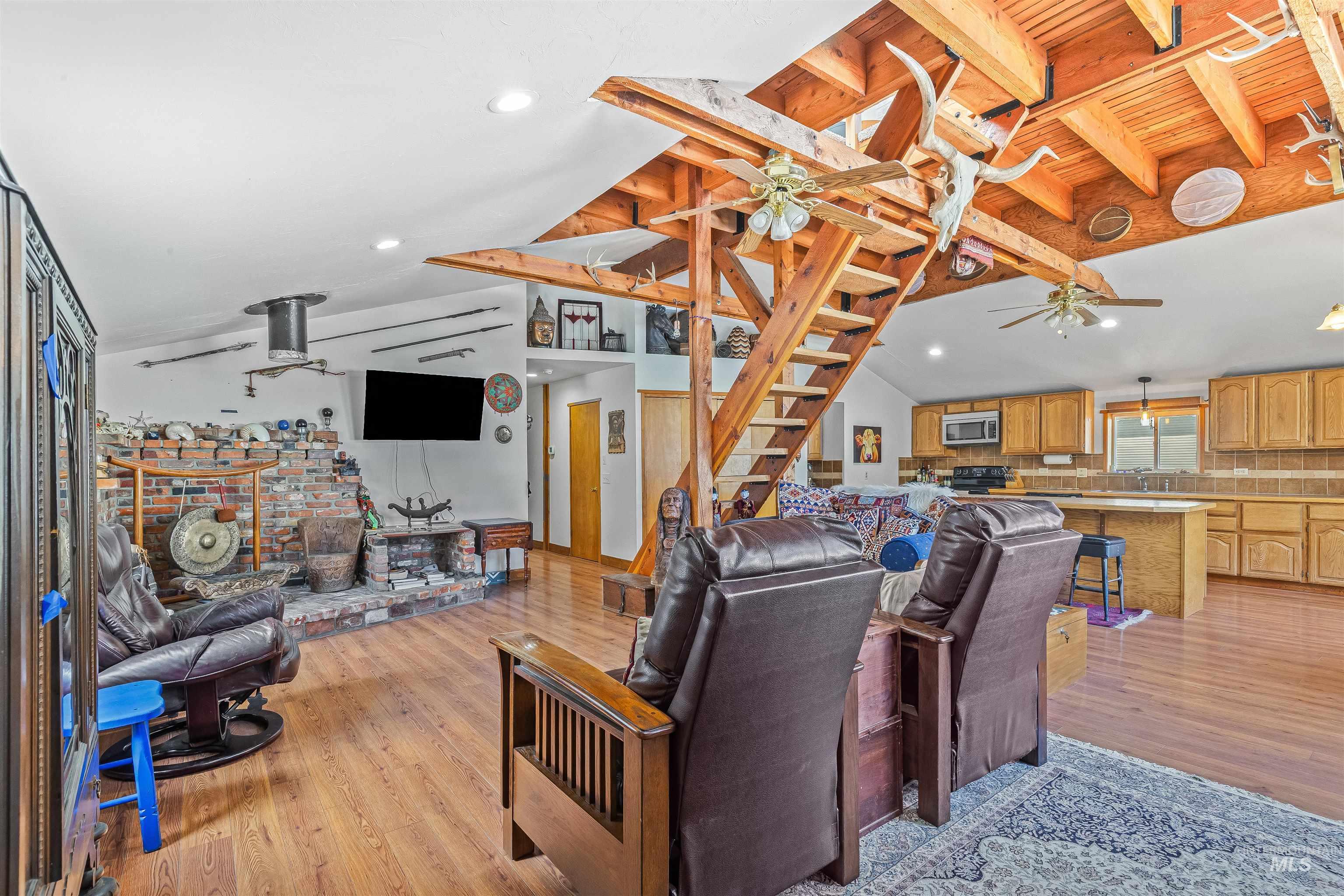 Living area featuring a ceiling fan, light wood-style floors, and recessed lighting