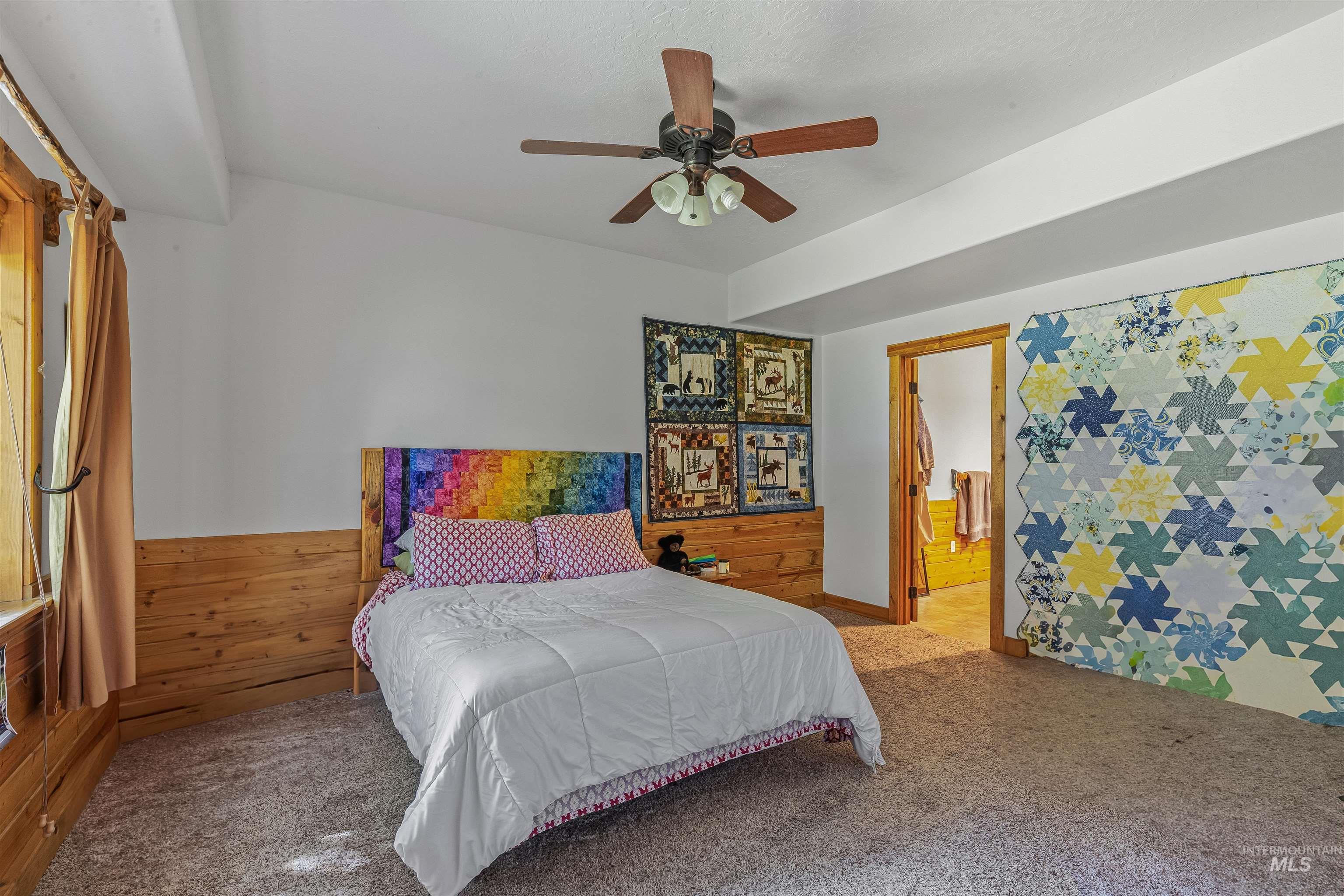 Carpeted bedroom with ceiling fan