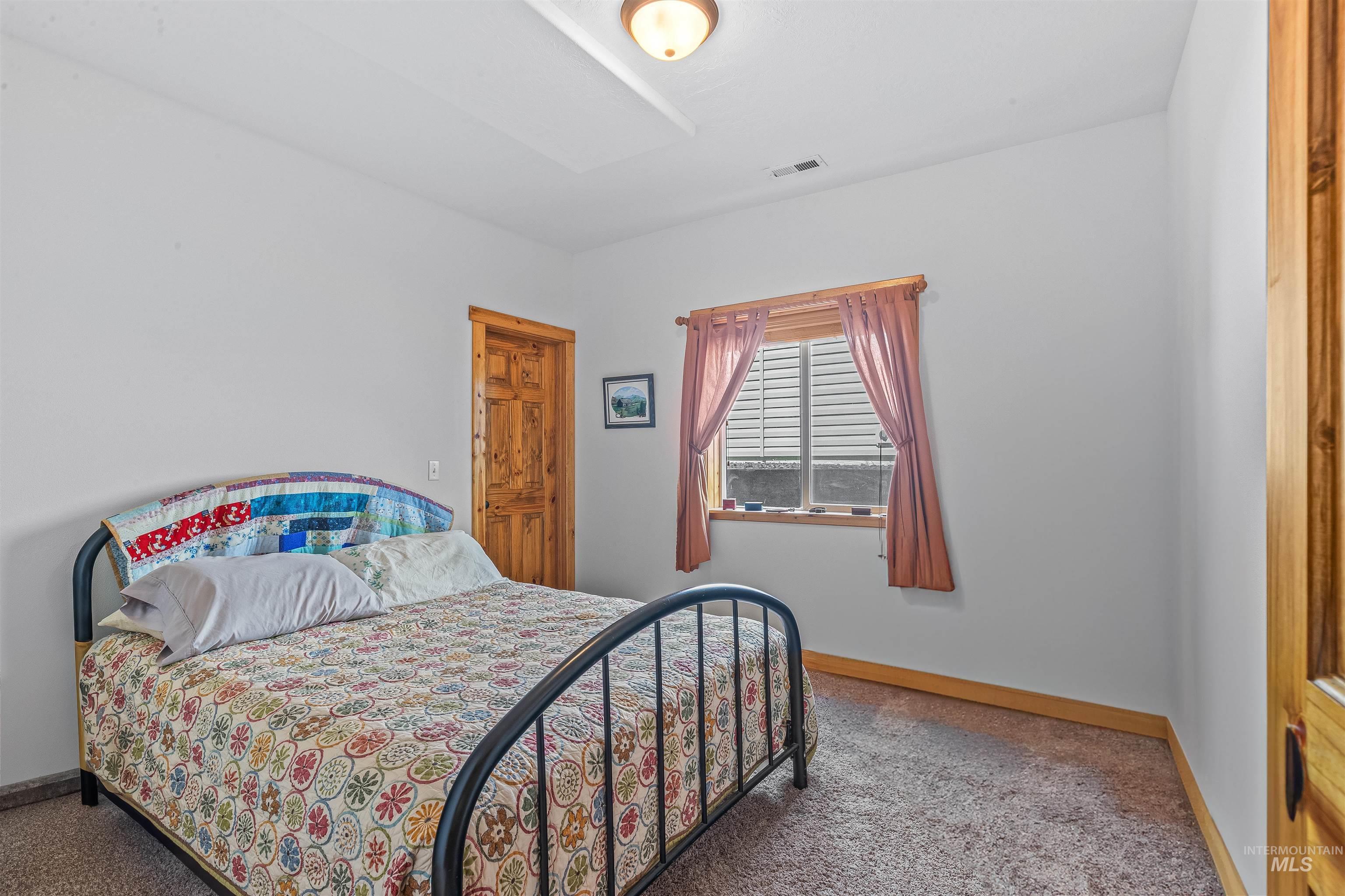 Carpeted bedroom with baseboards