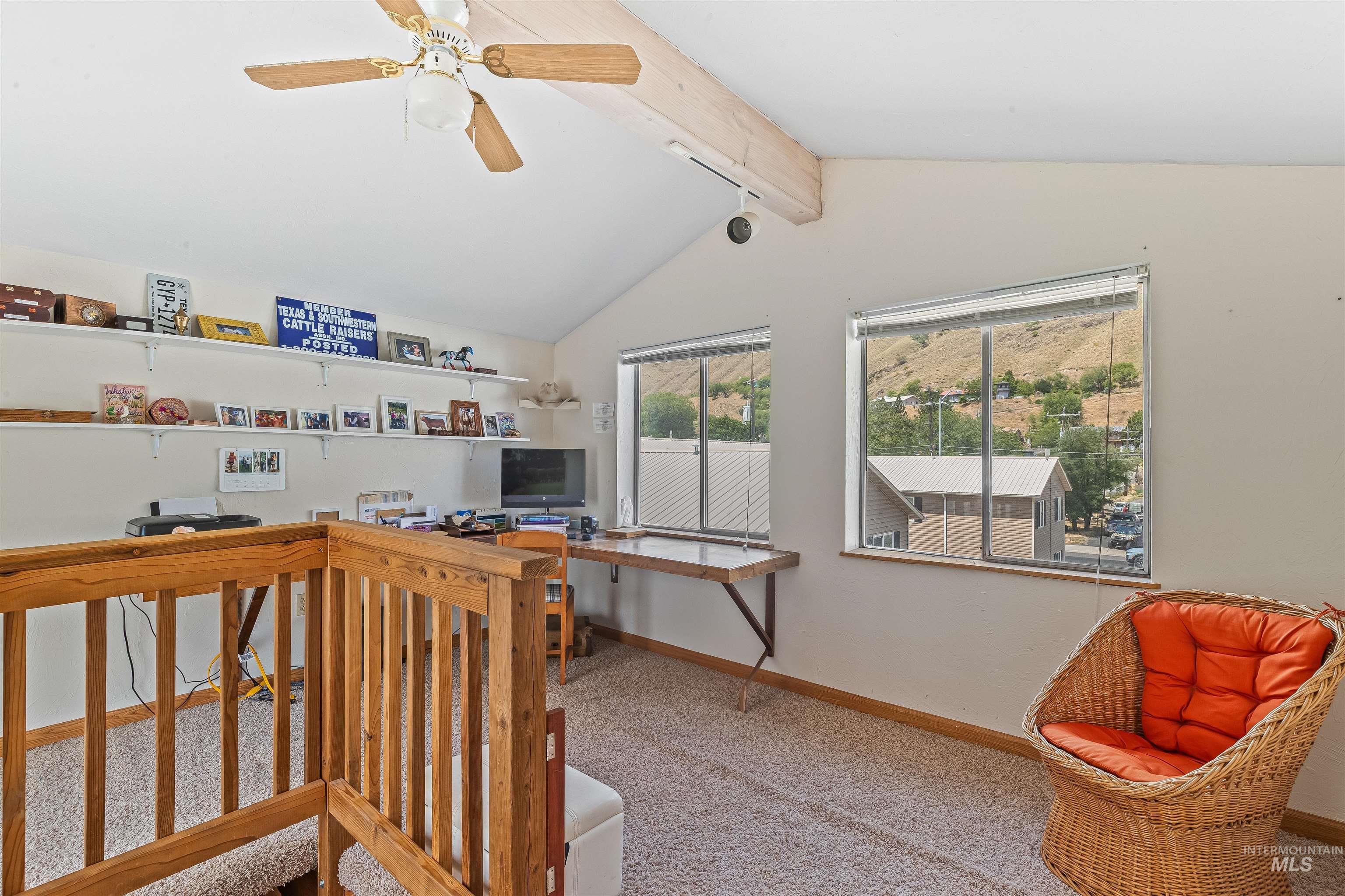 Carpeted office with baseboards and ceiling fan