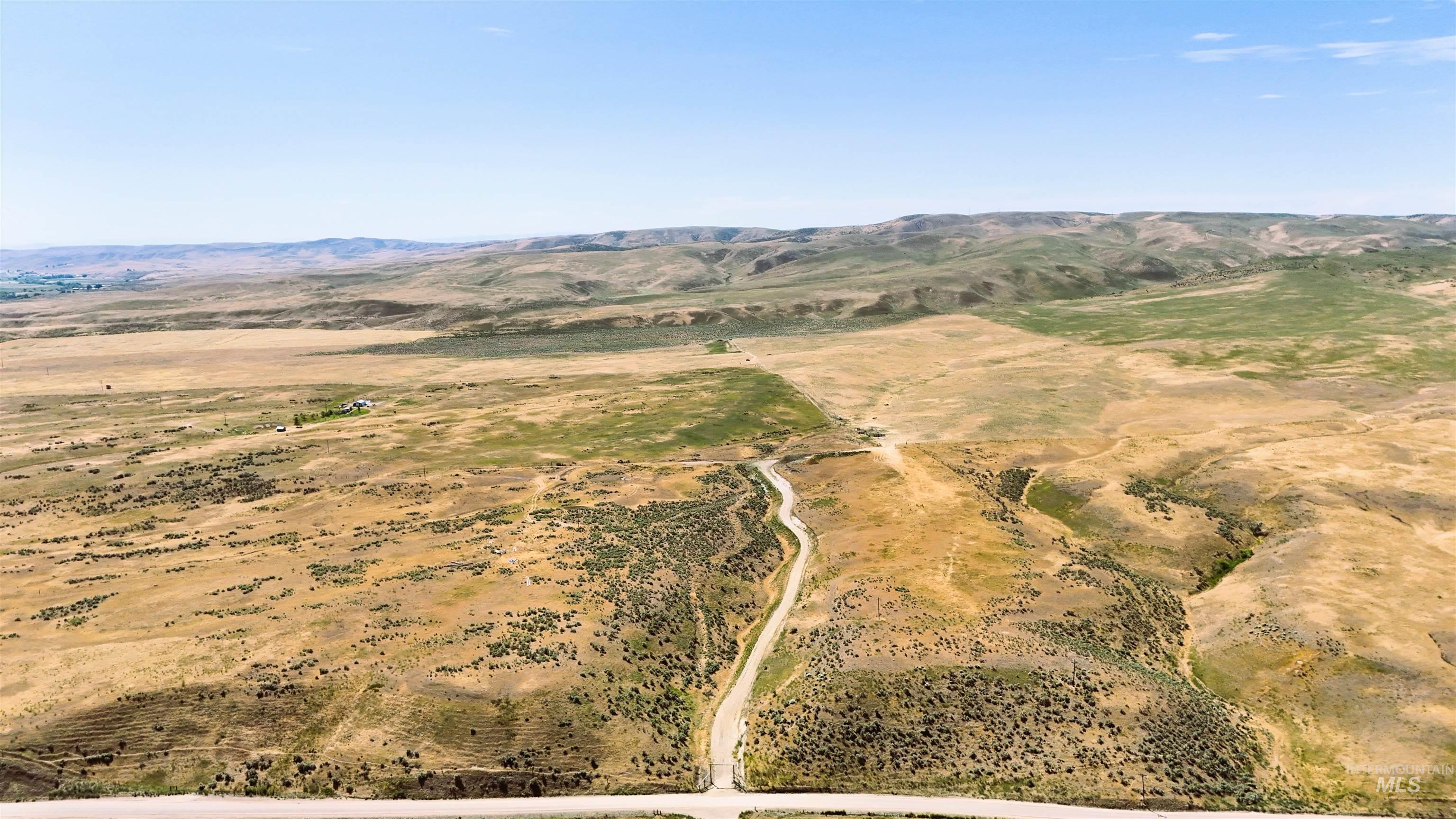 Aerial view of property's location featuring a mountain backdrop and rural landscape