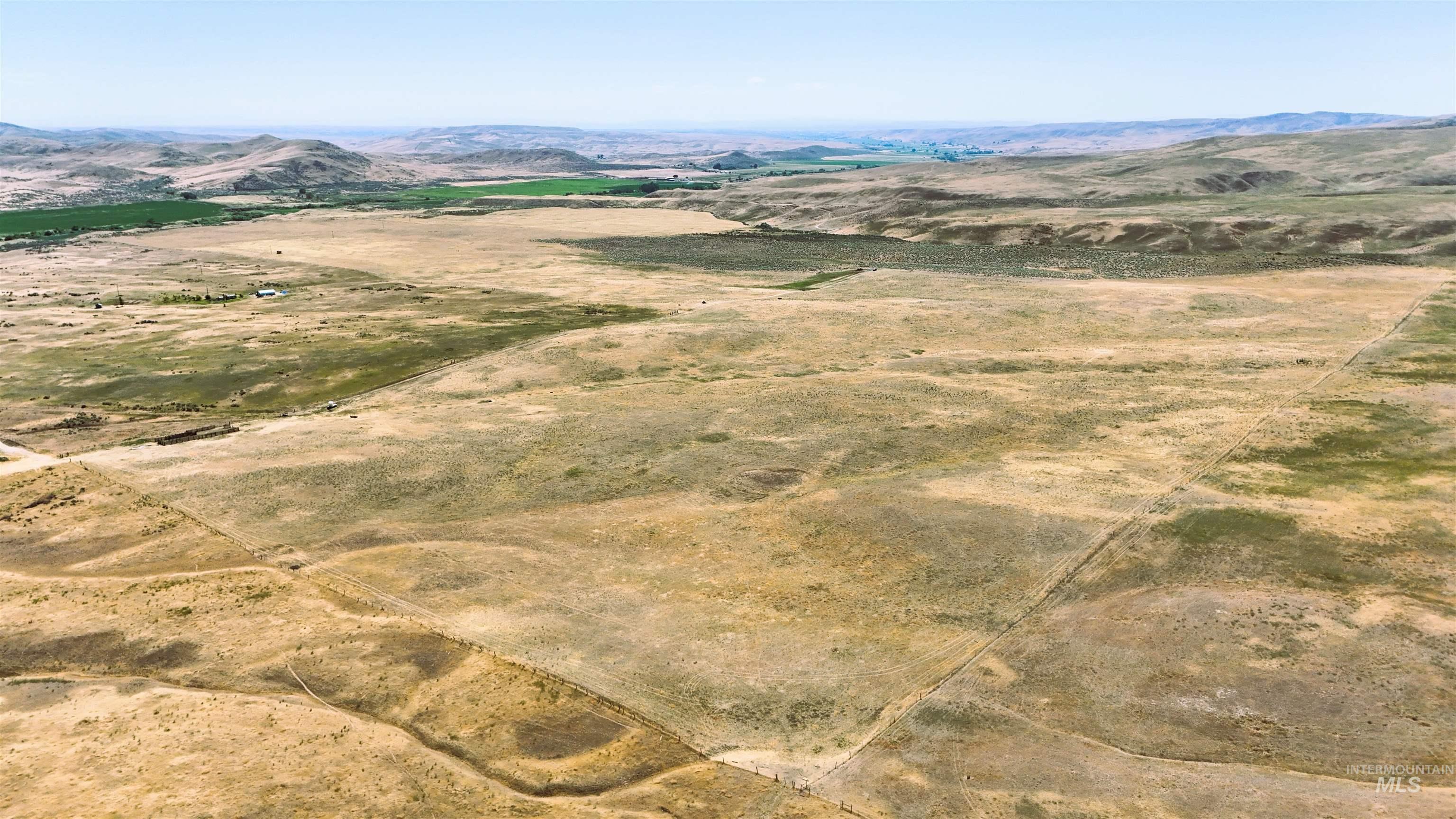 Aerial overview of property's location featuring a mountain backdrop and rural landscape