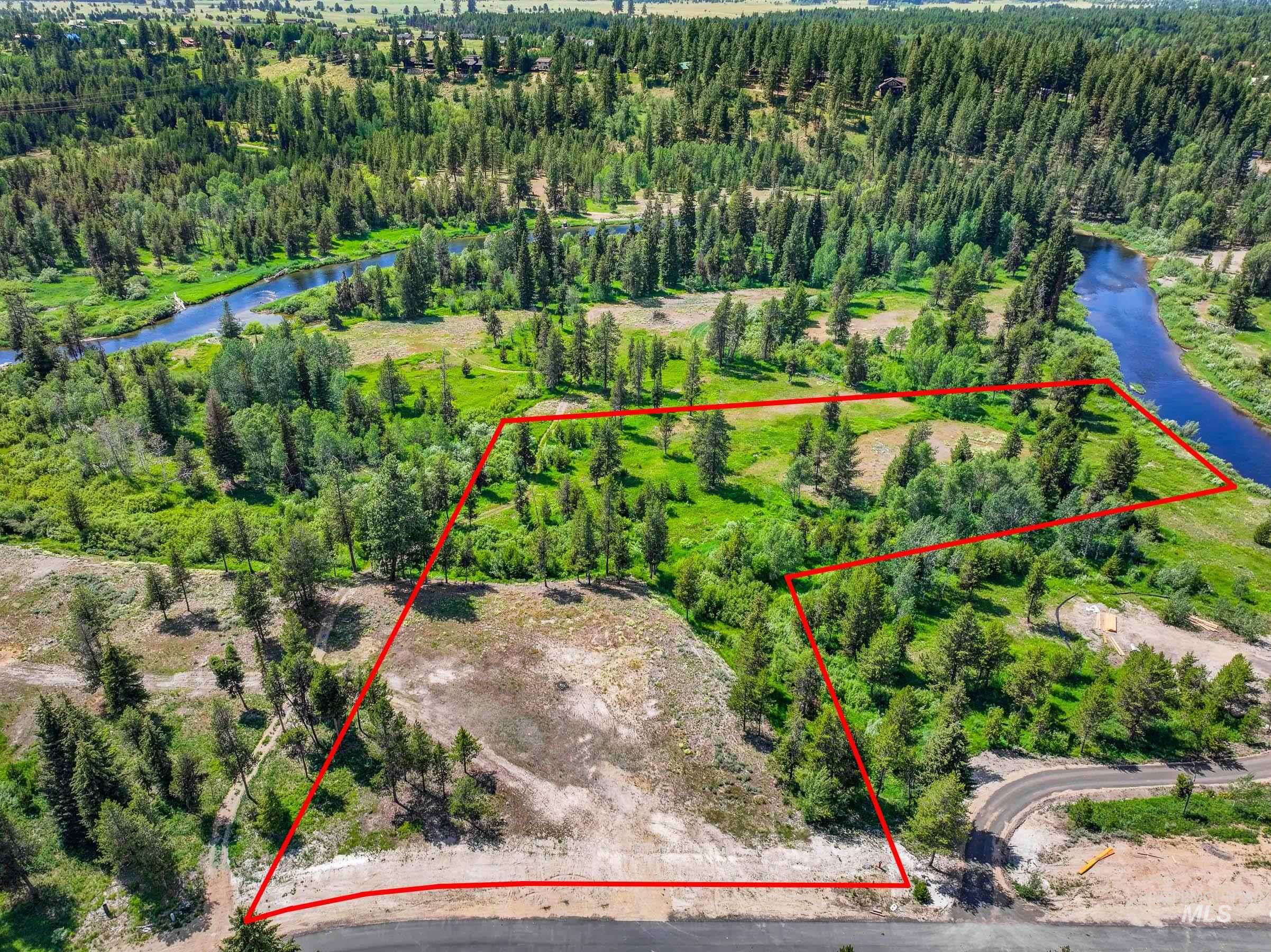 Aerial view of property's location with a nearby body of water and property boundaries highlighted