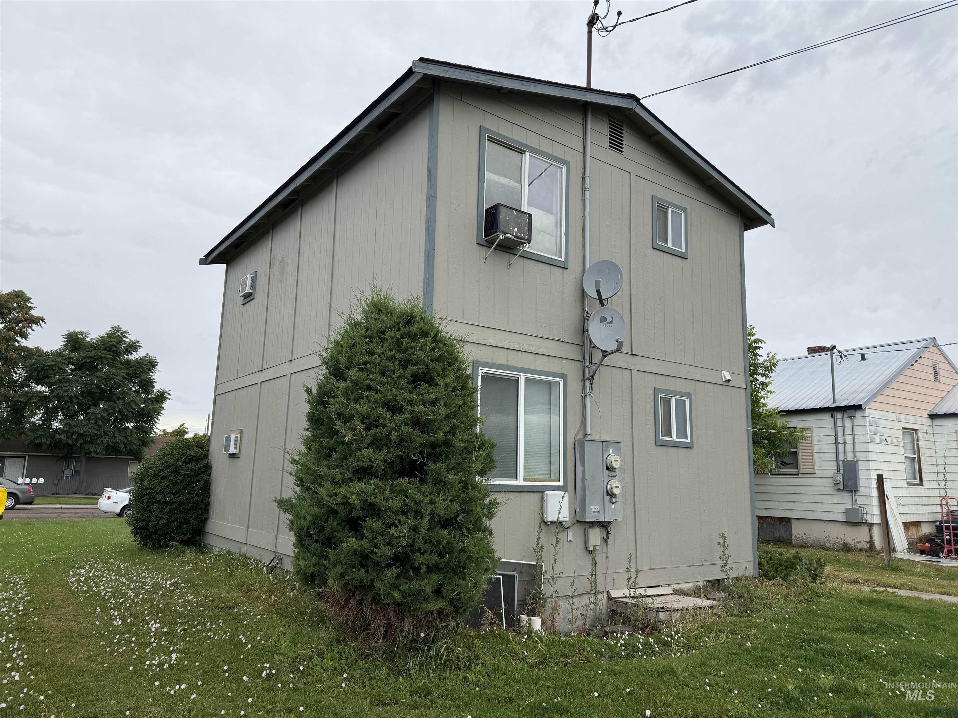Rear view of property with a lawn