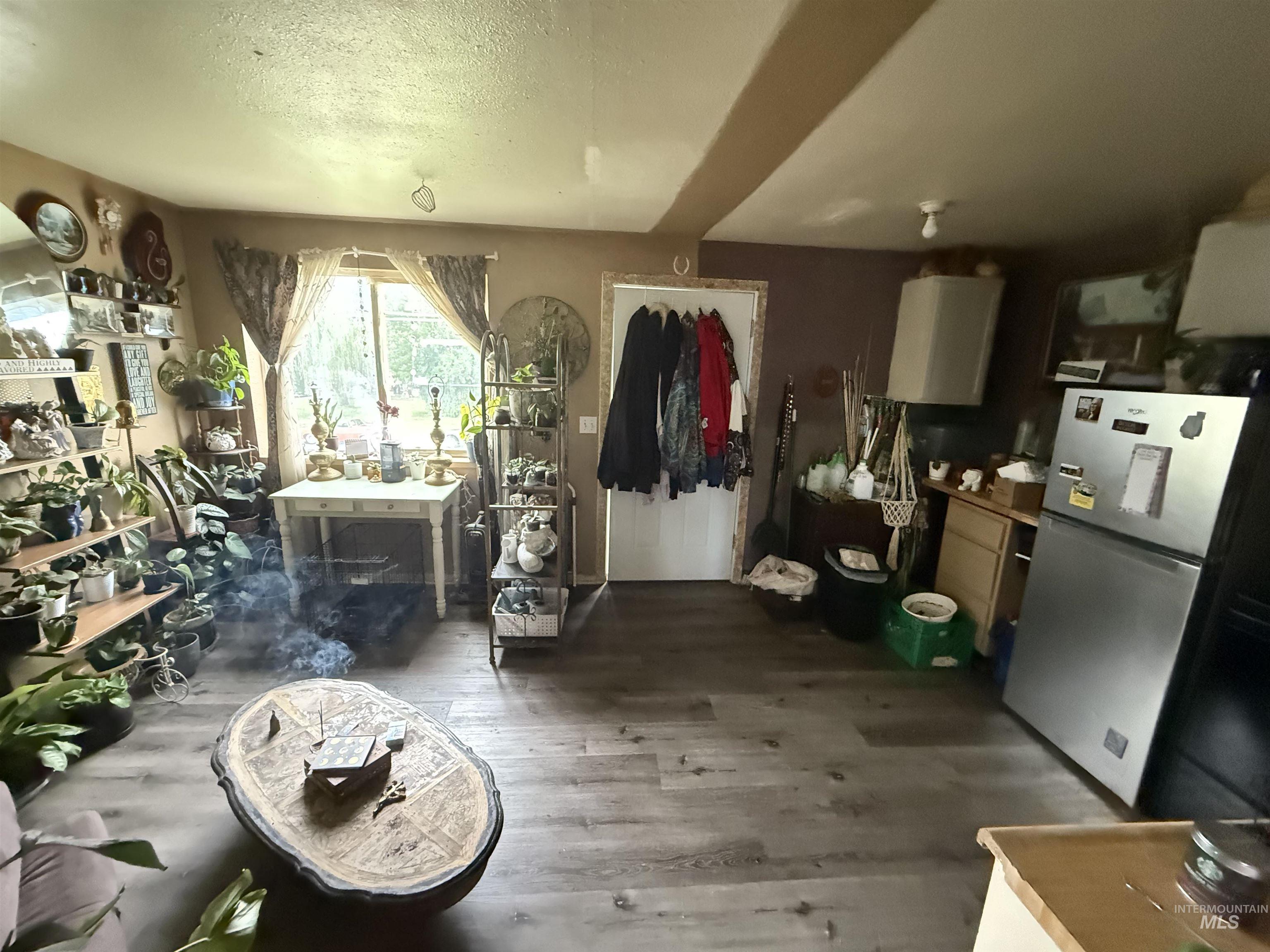 Misc room with wood finished floors and a textured ceiling