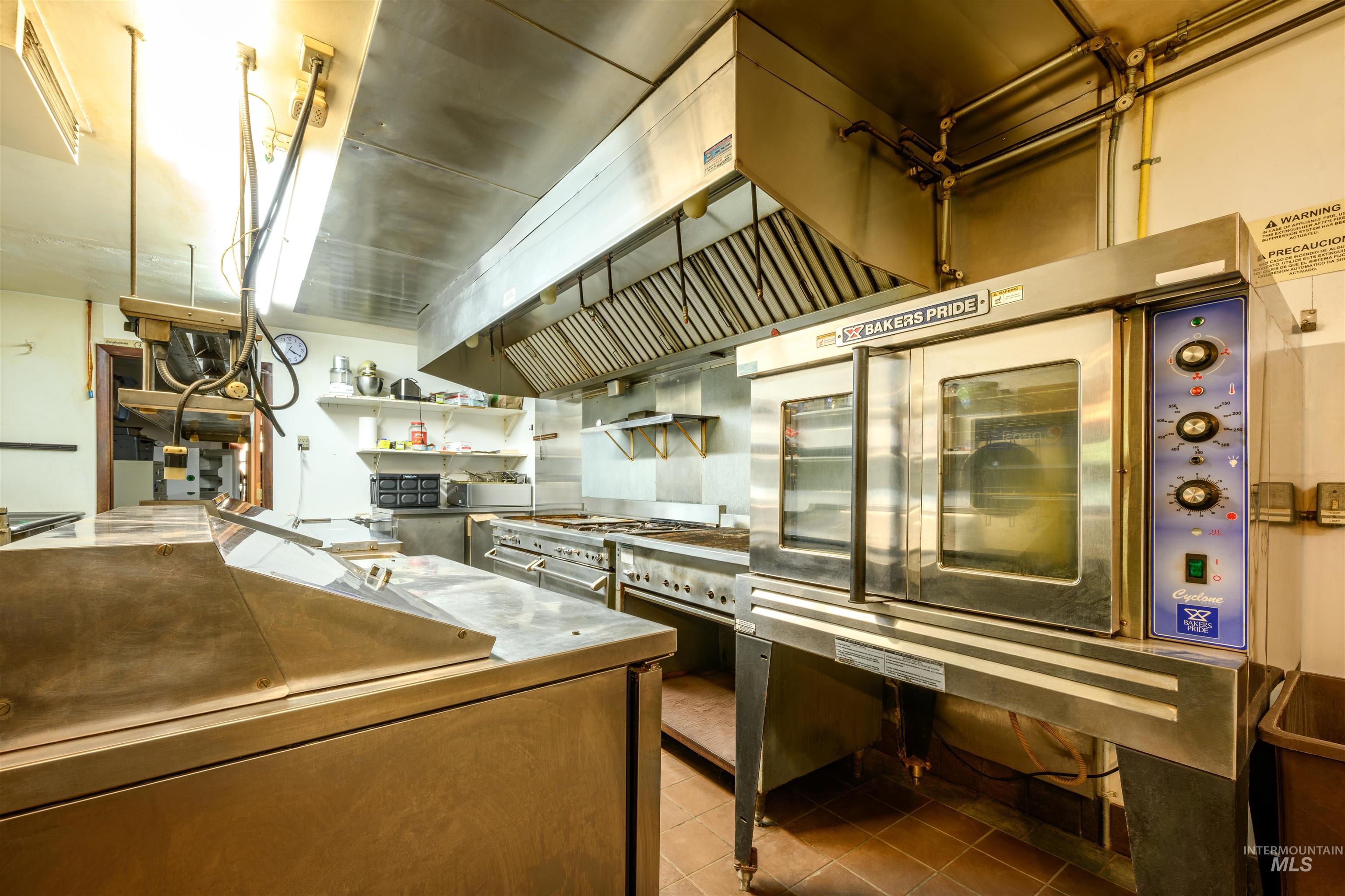 Commercial oven, stove and grill, deep fry, convection oven, deli fridges, walk-in refrigerator, walk-in freezer, and fire suppression system.