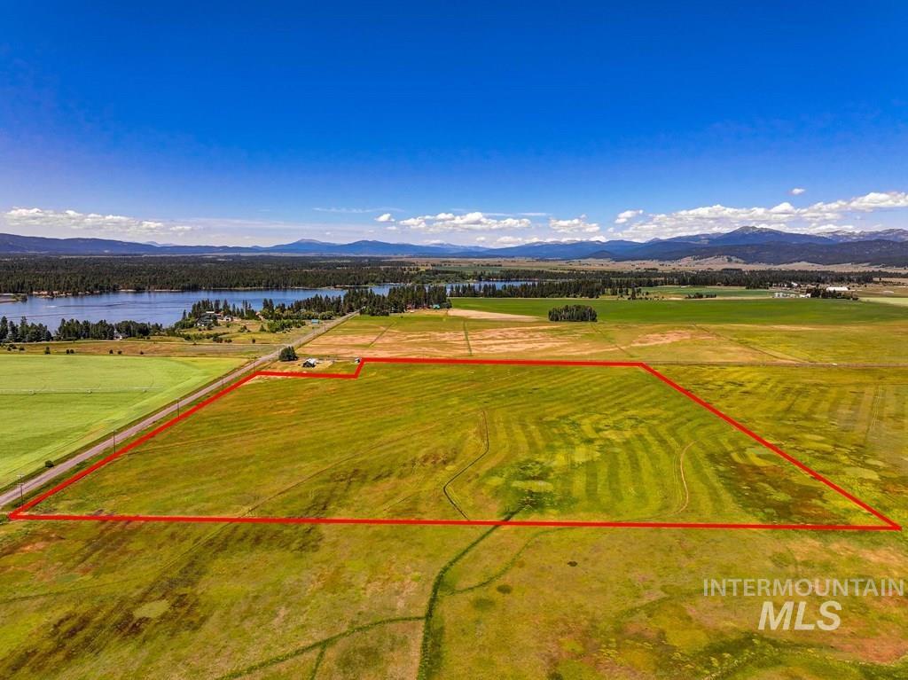 Aerial view of property and surrounding area with a water and mountain view and property boundaries highlighted