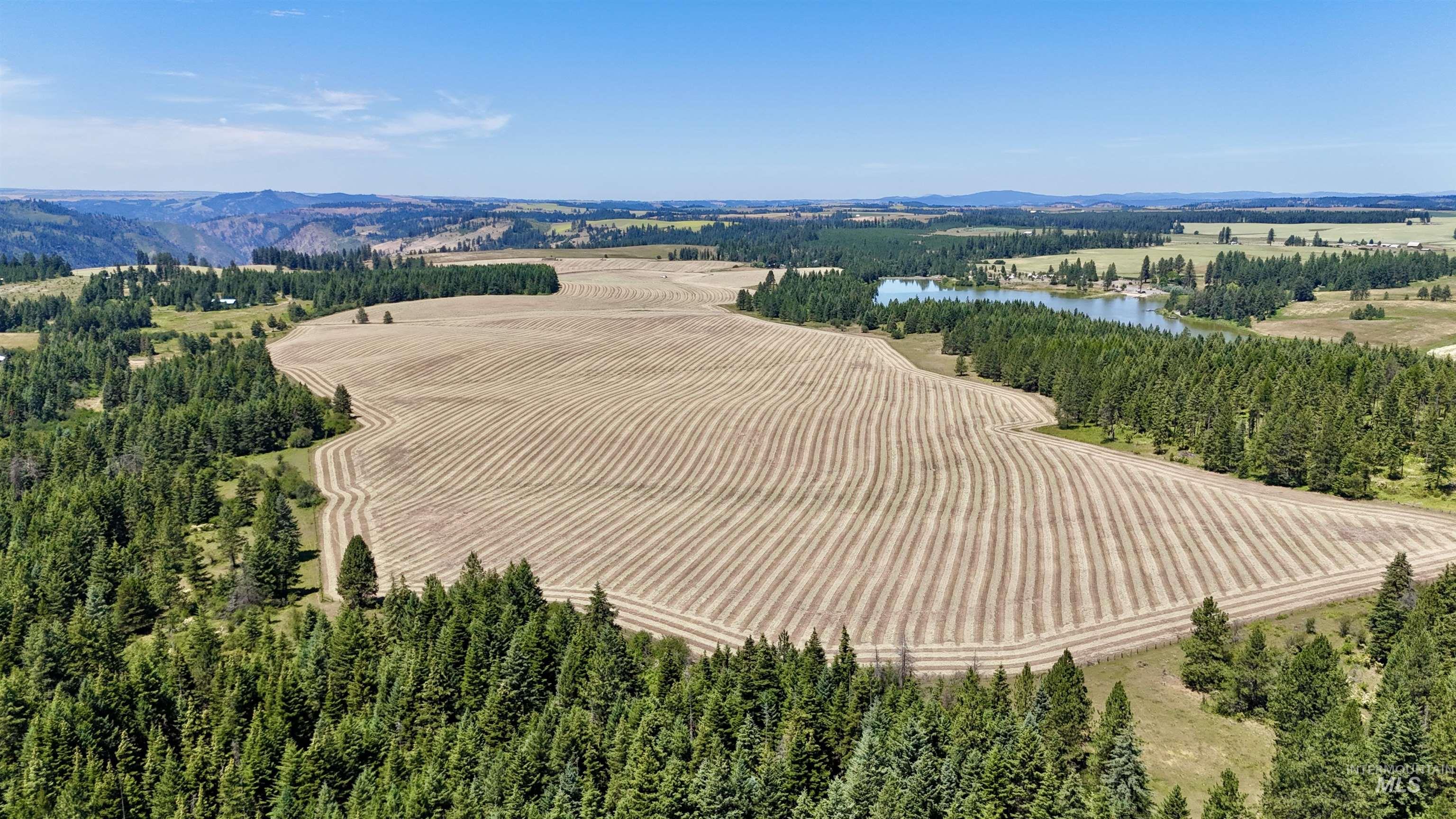 Aerial view of sparsely populated area featuring a water and mountain view