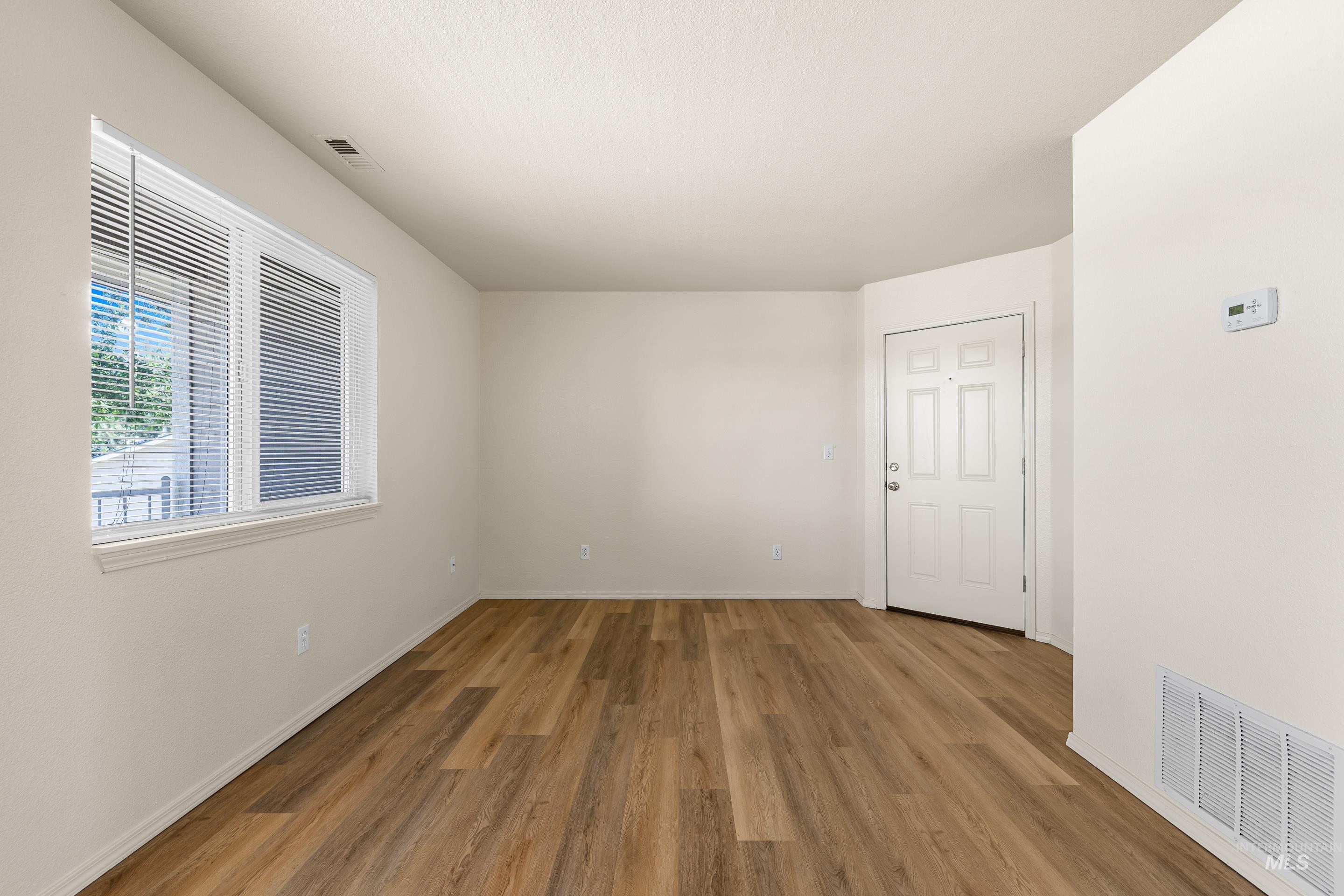 Livingroom featuring light wood LVP flooring and baseboards.