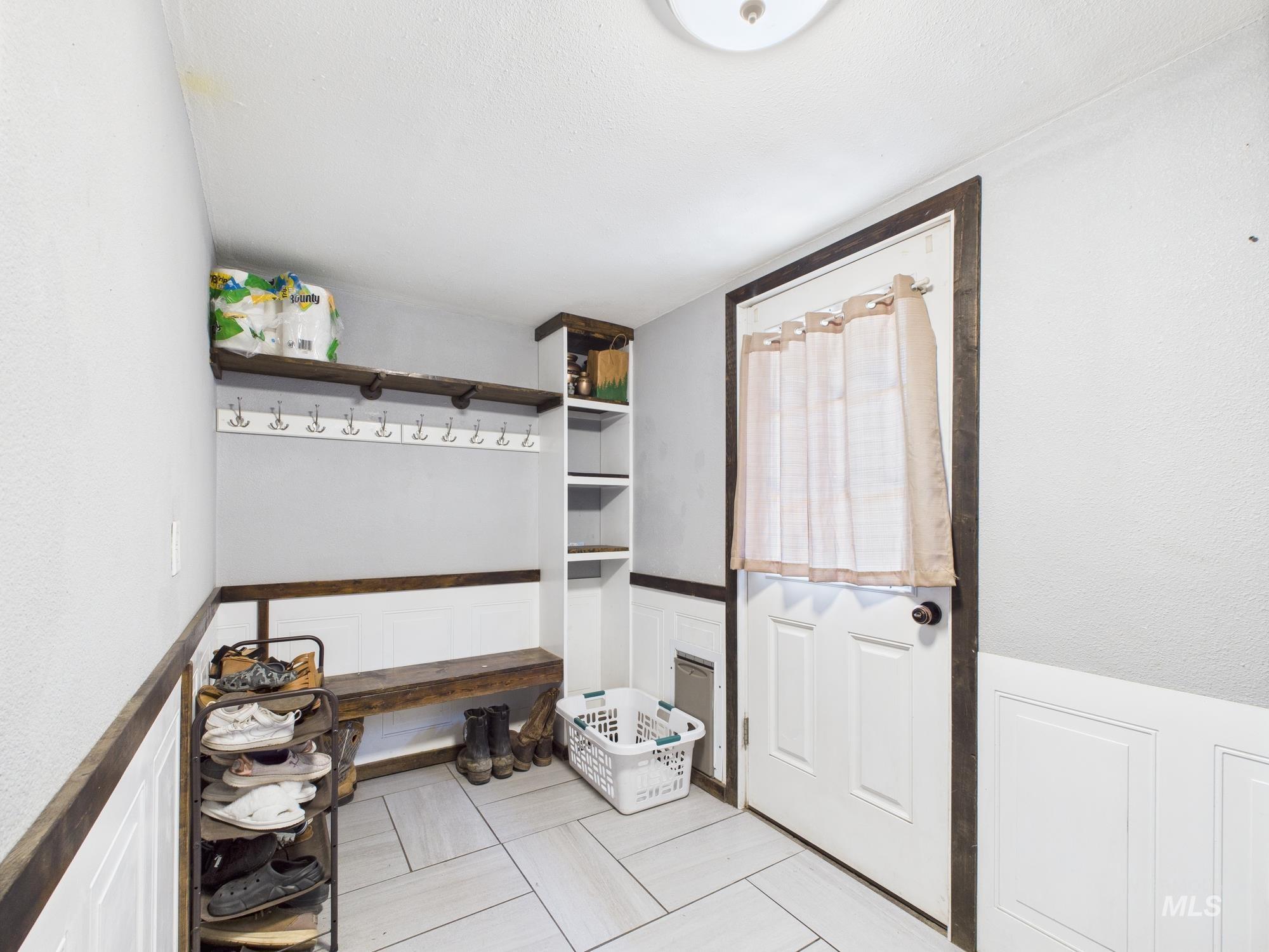 Mudroom featuring wainscoting