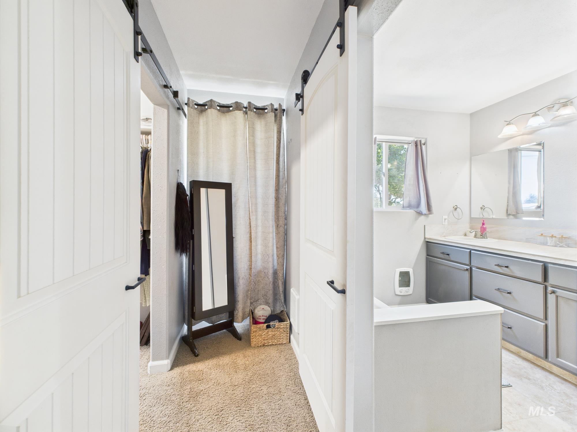 Full bath featuring vanity and a closet