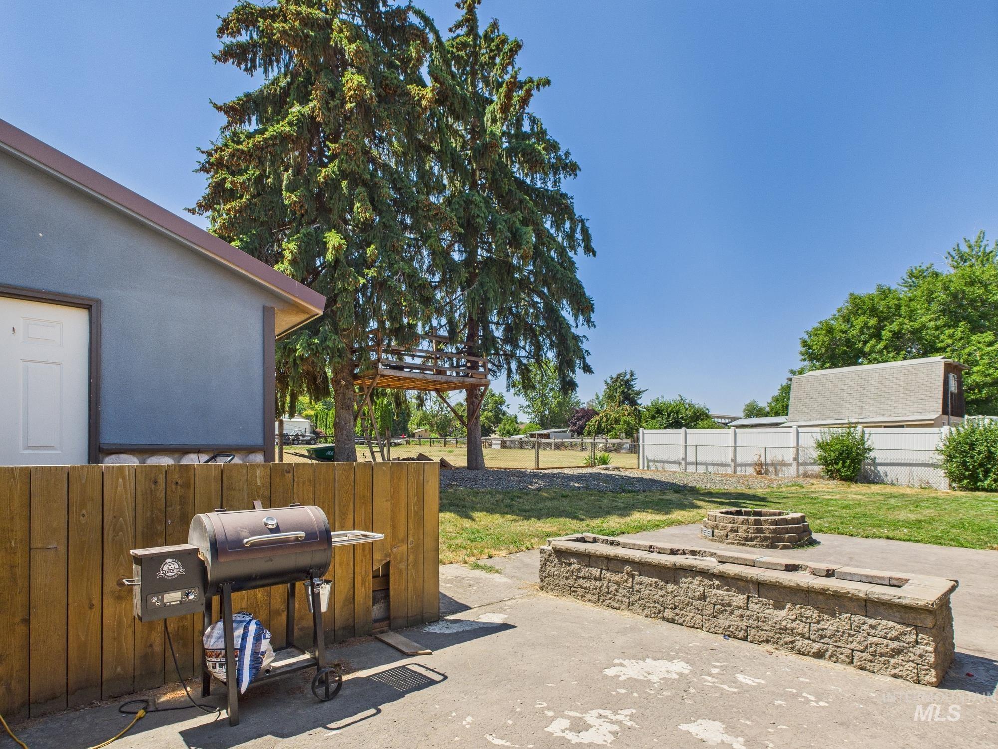 View of patio / terrace with a fire pit and grilling area