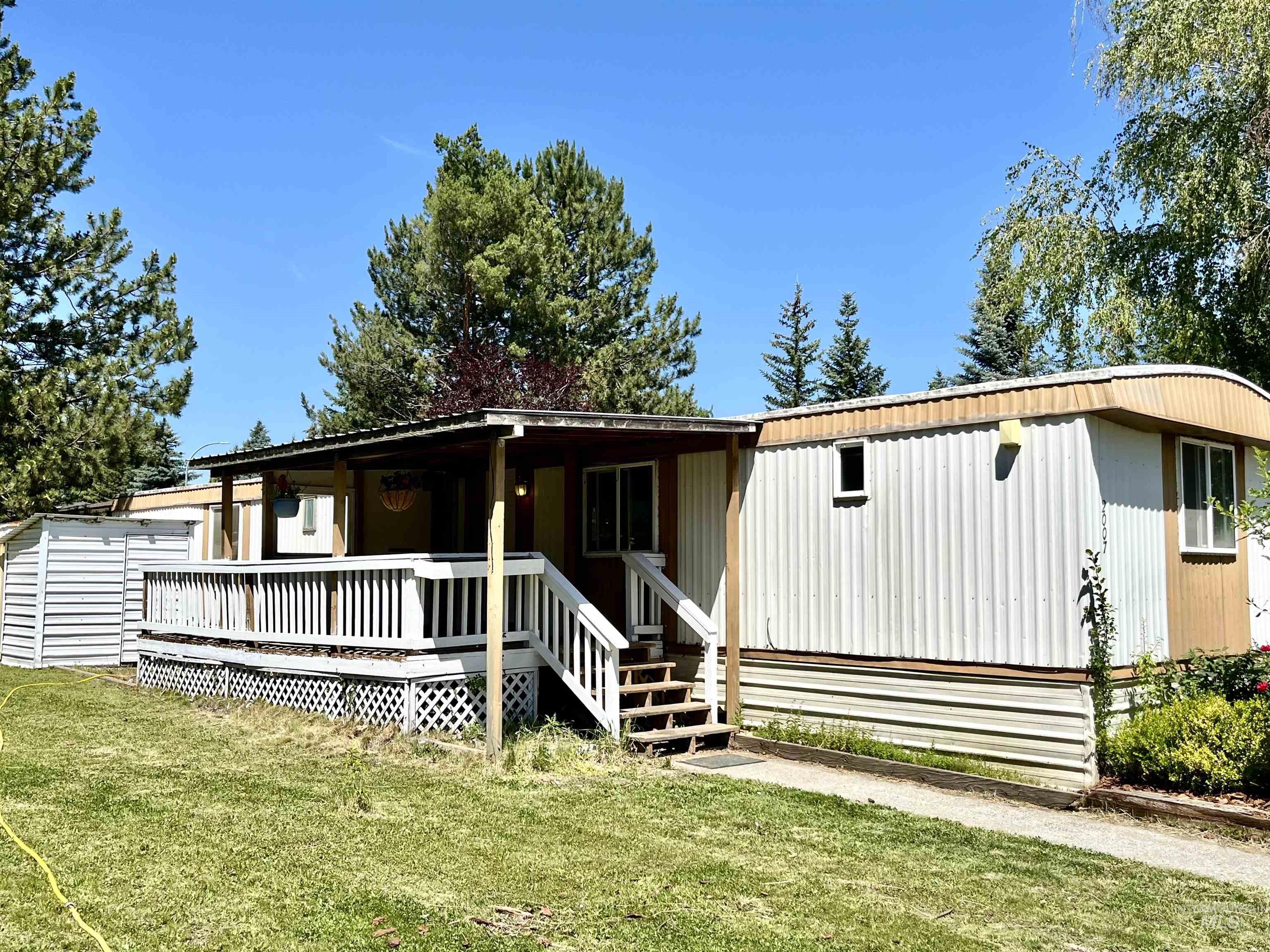 View of front of home with a front yard and covered porch