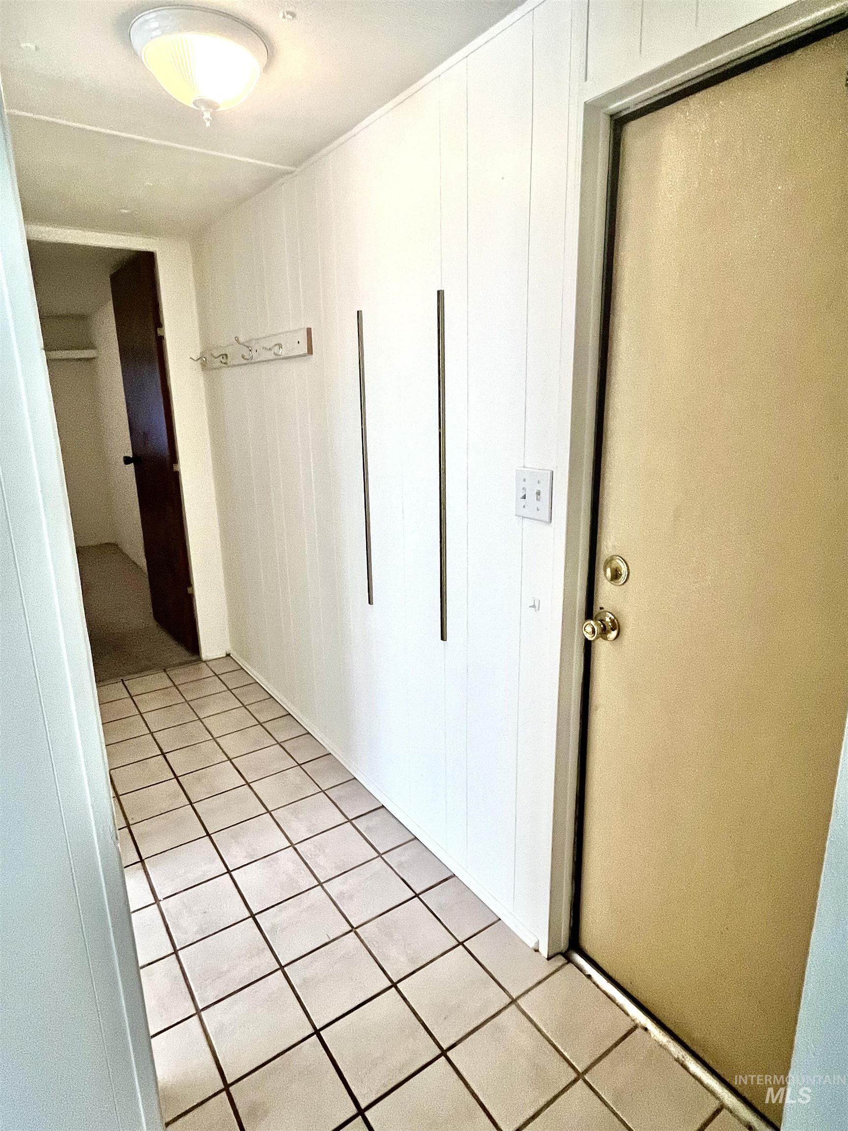 Hallway featuring light tile patterned flooring