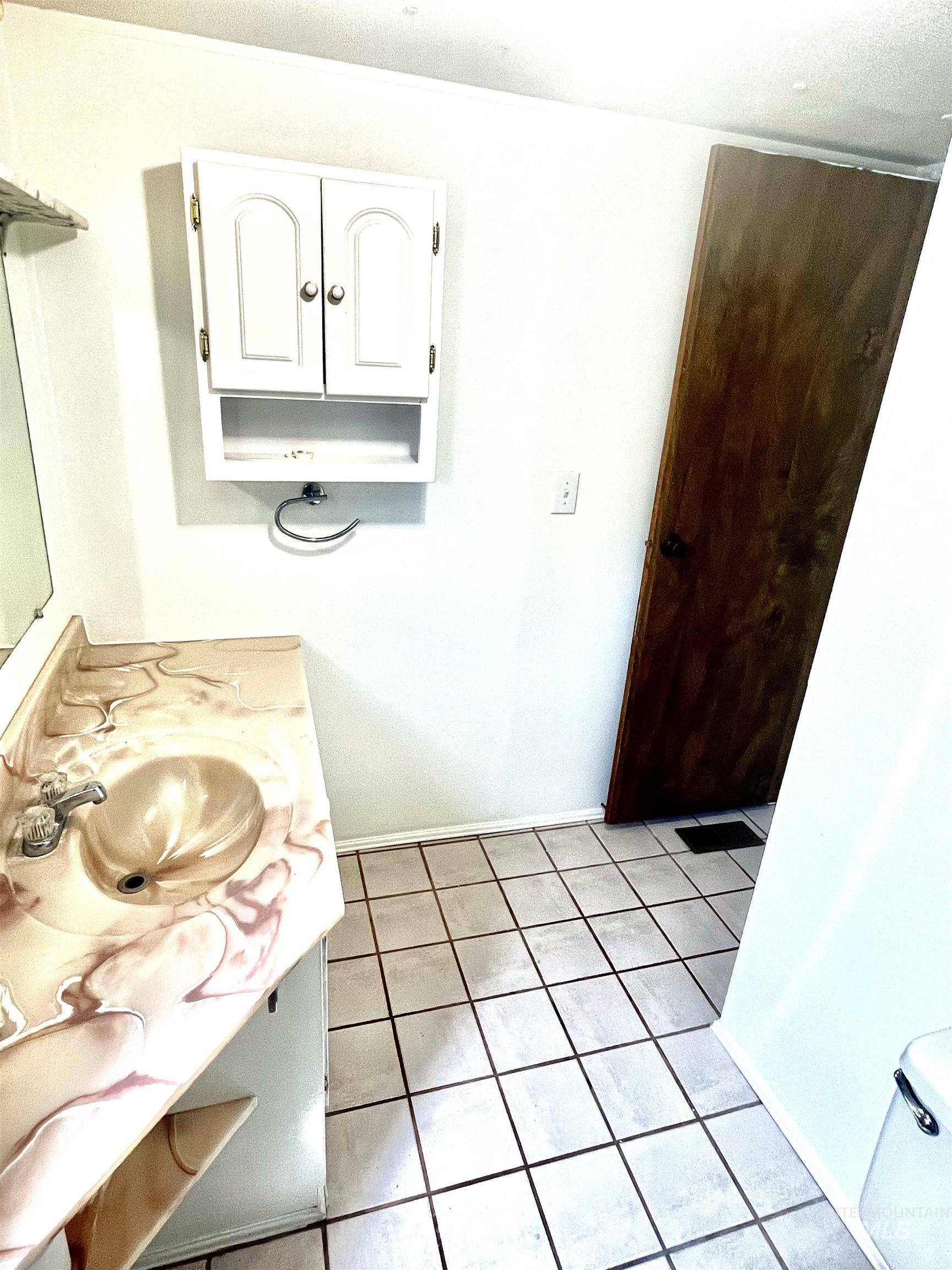 Bathroom with vanity and baseboards