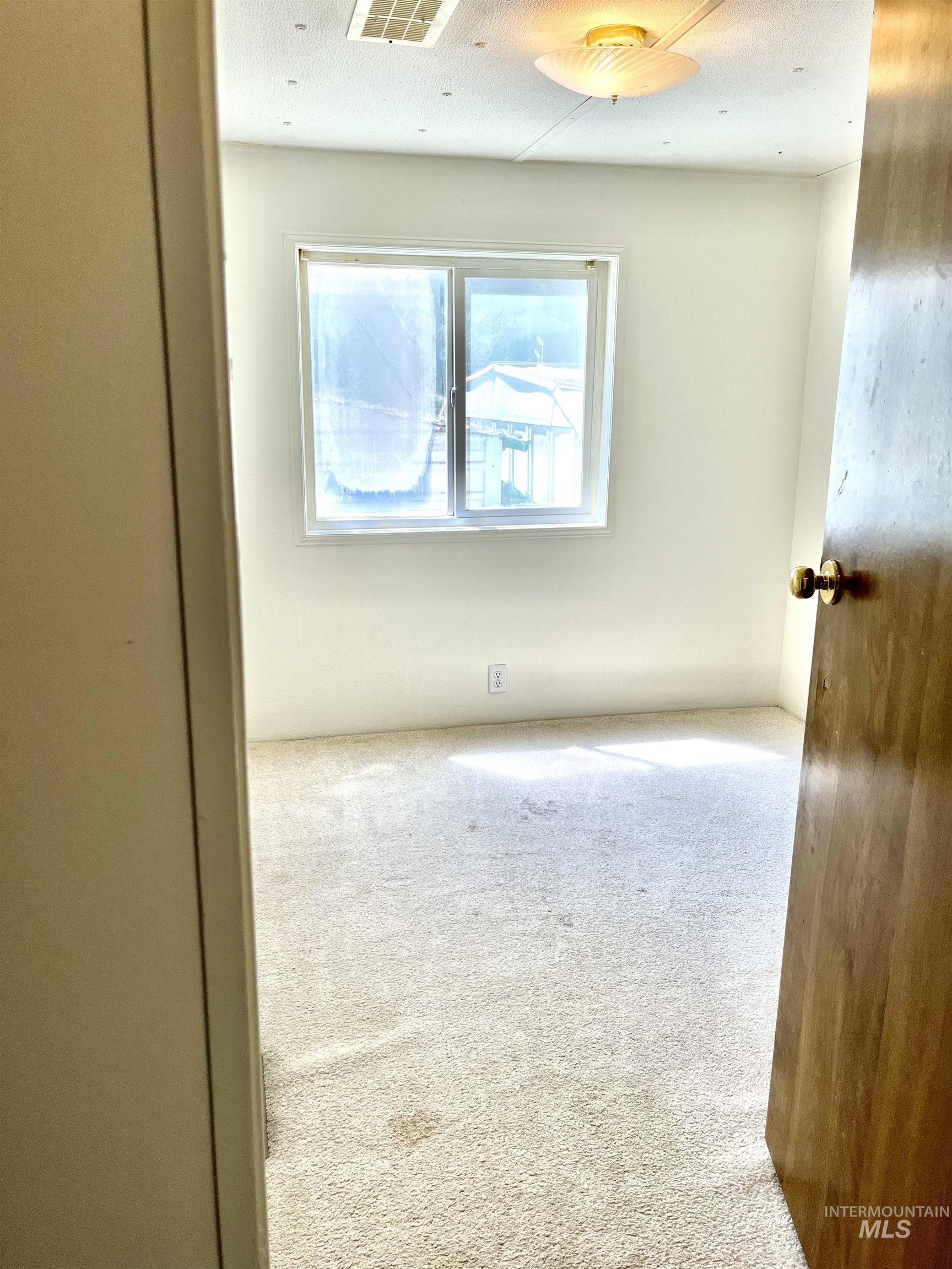 Empty room featuring carpet