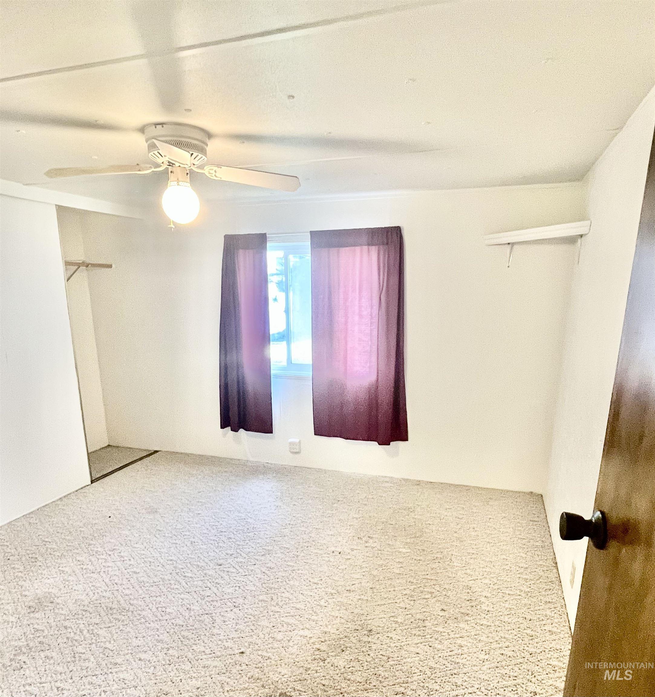 Unfurnished bedroom with carpet flooring, ceiling fan, and a closet