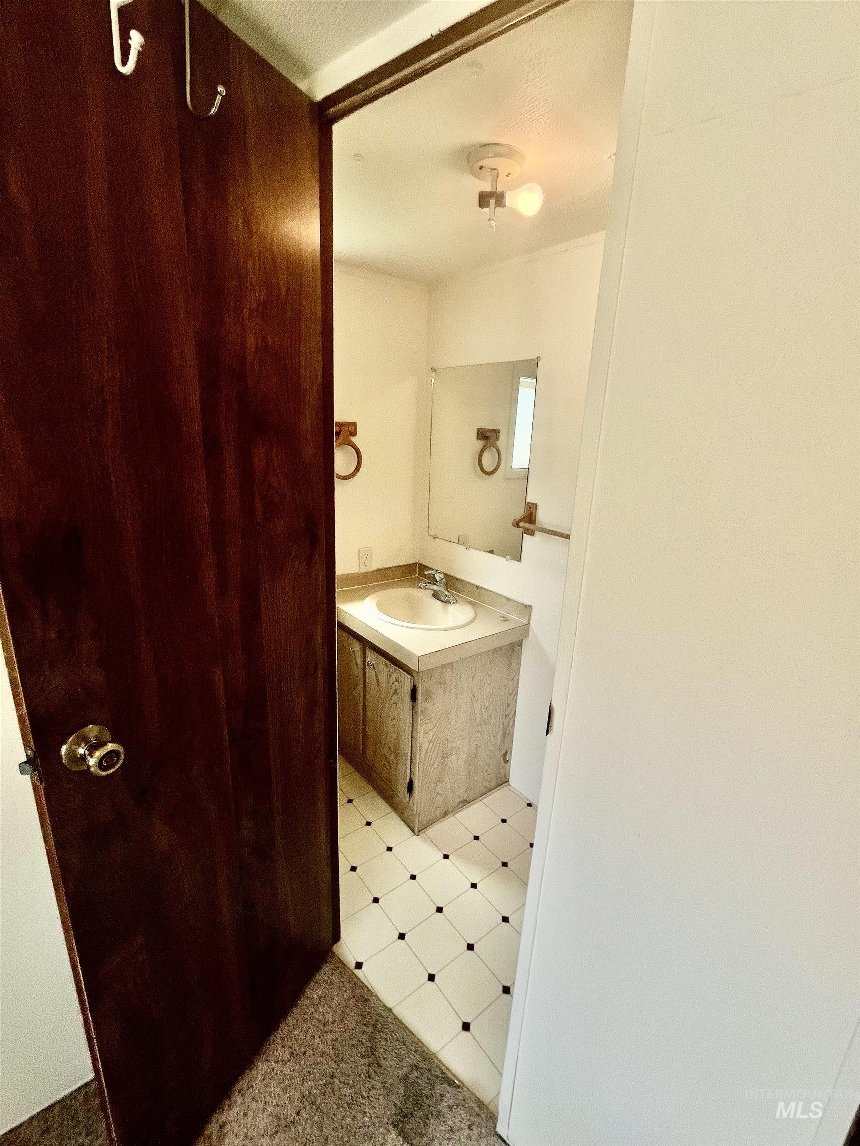 Bathroom featuring vanity and tile patterned floors