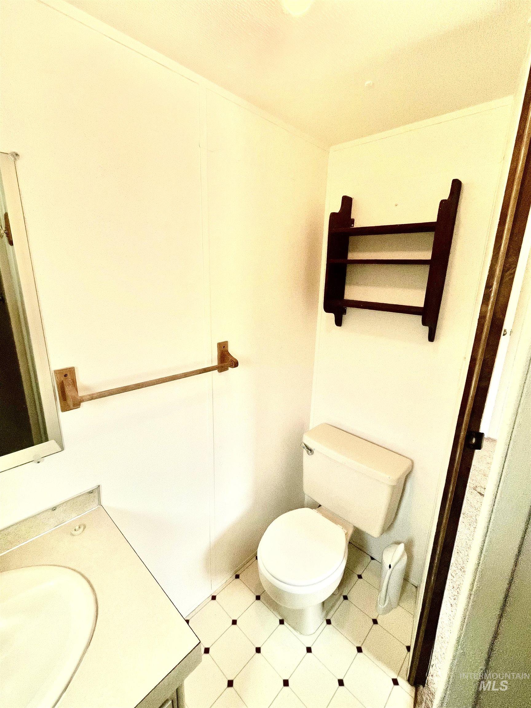 Half bath featuring vanity and tile patterned floors