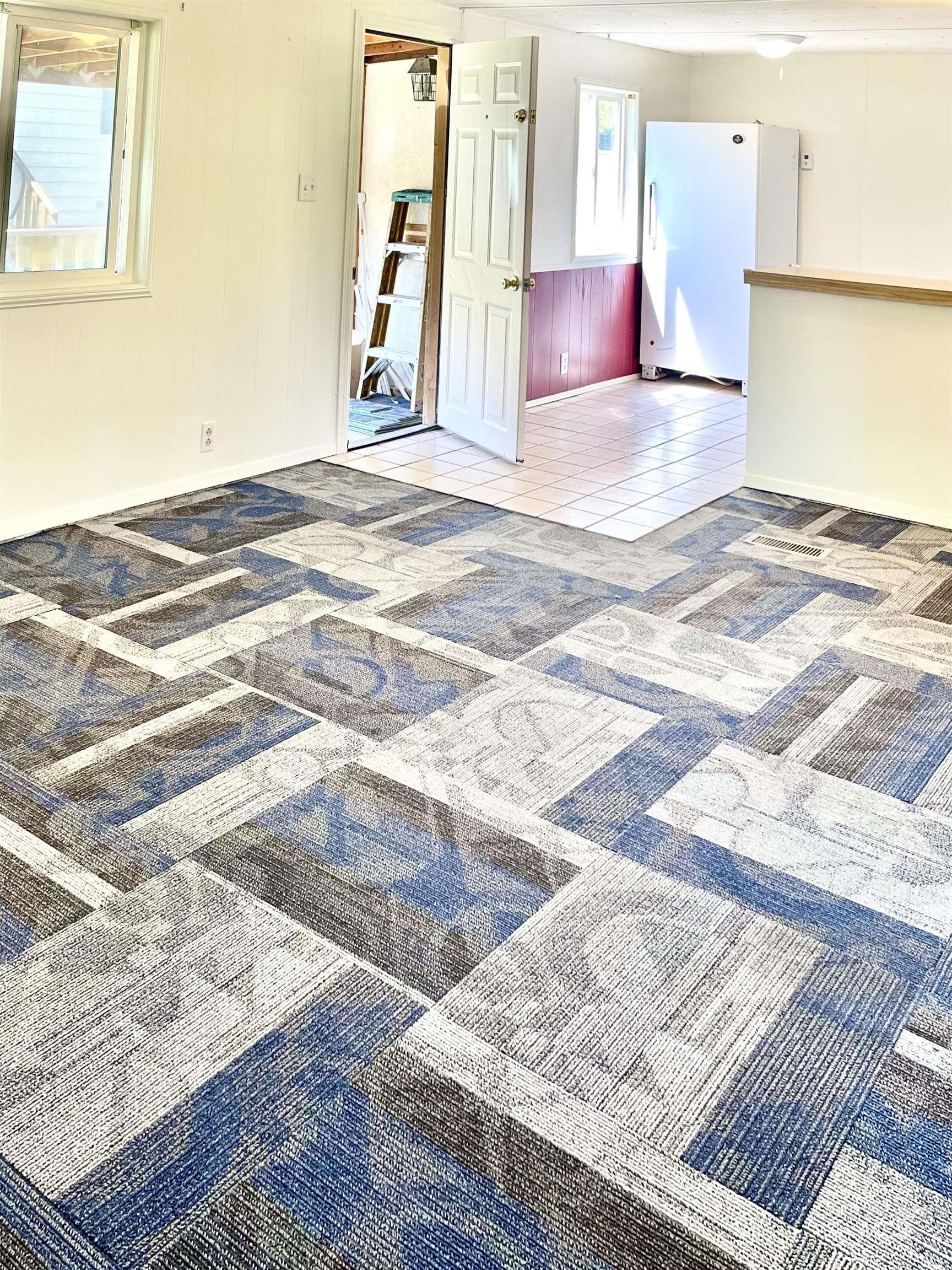 Carpeted empty room featuring baseboards
