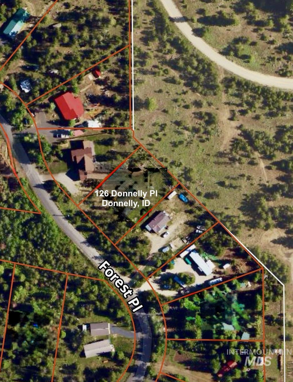 Aerial map of property and surrounding area featuring property boundaries highlighted
