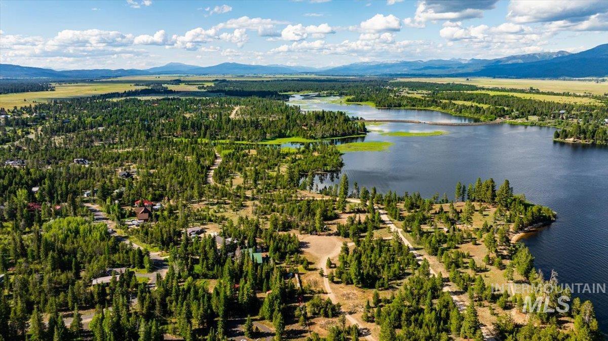 Aerial view of a water and mountain view and a heavily wooded area