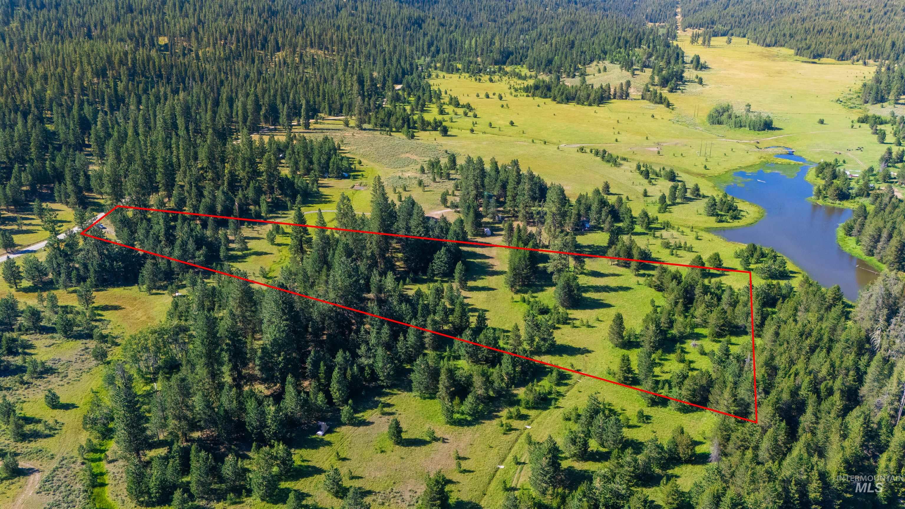 Aerial view of property\'s location featuring a nearby body of water and property boundaries highlighted