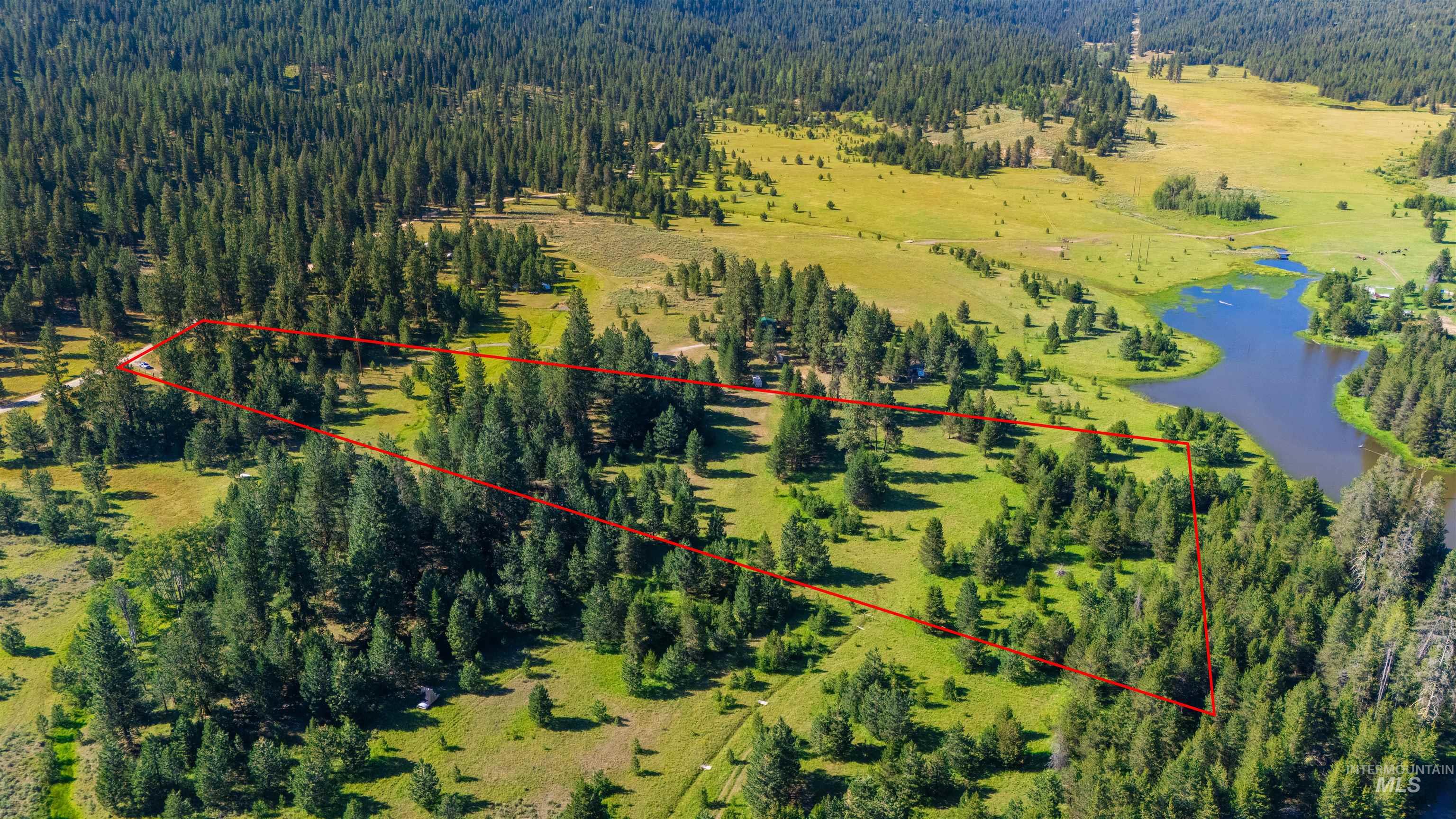 Aerial view of property\'s location featuring a nearby body of water and property parcel outlined