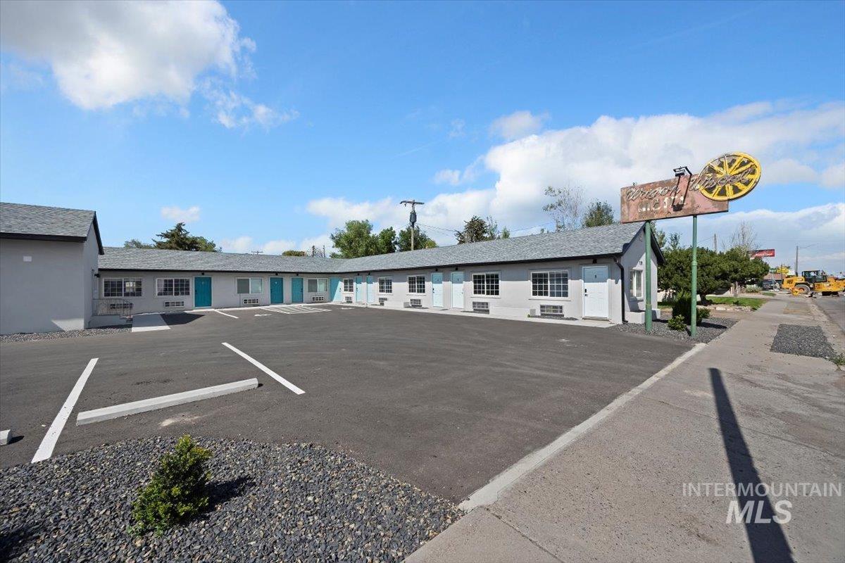 View of property with uncovered parking
