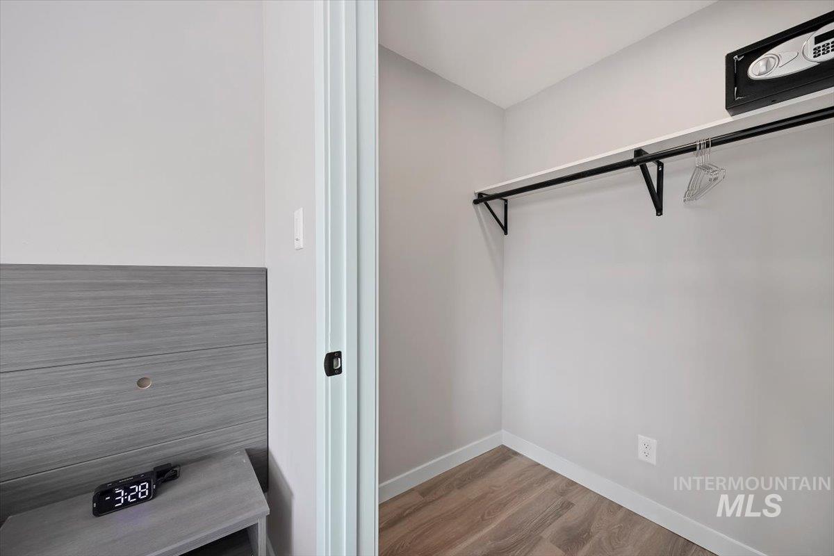 Spacious closet featuring wood finished floors